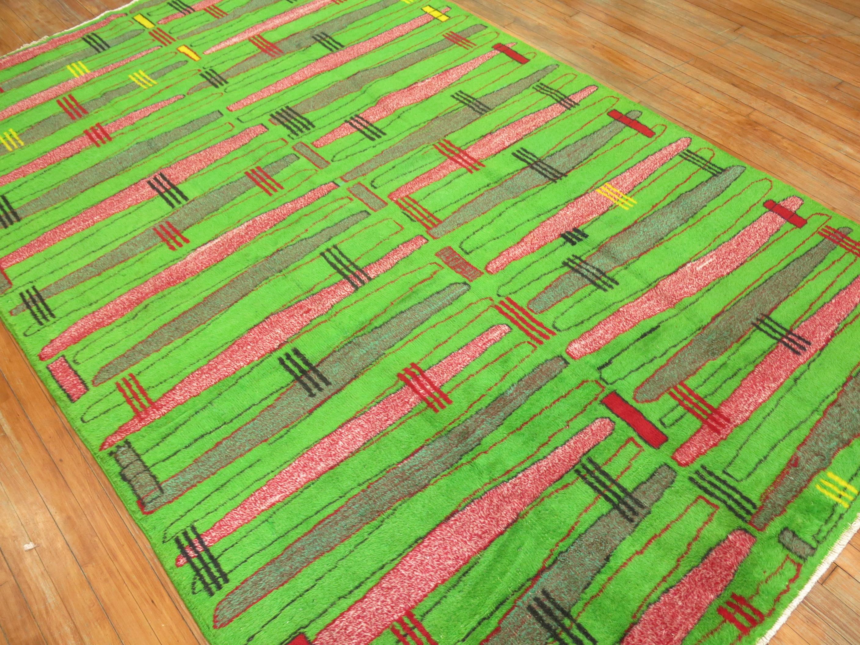A mid-20th century bright neon green field Turkish Sparta rug with a deco inspired motif.

6'4'' x 10'4''