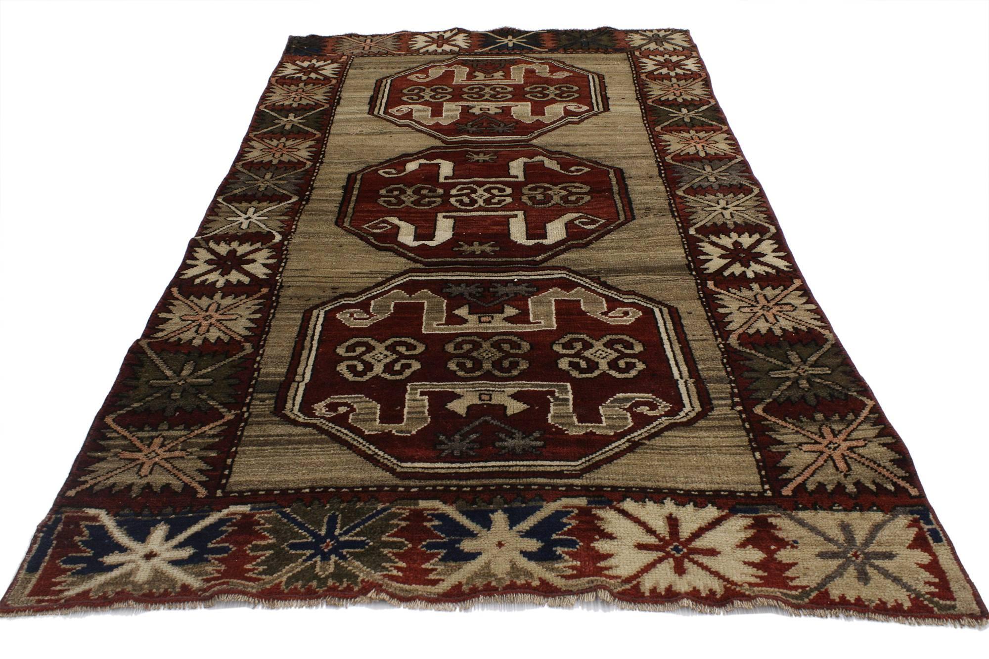 52109, Vintage Turkish Oushak Accent Rug with Rustic Lodge Tribal Style. This gorgeous hand-knotted wool Turkish Oushak rug features three octagonal medallions patterned with tribal symbols on a field of striated neutral colors. Geometric star