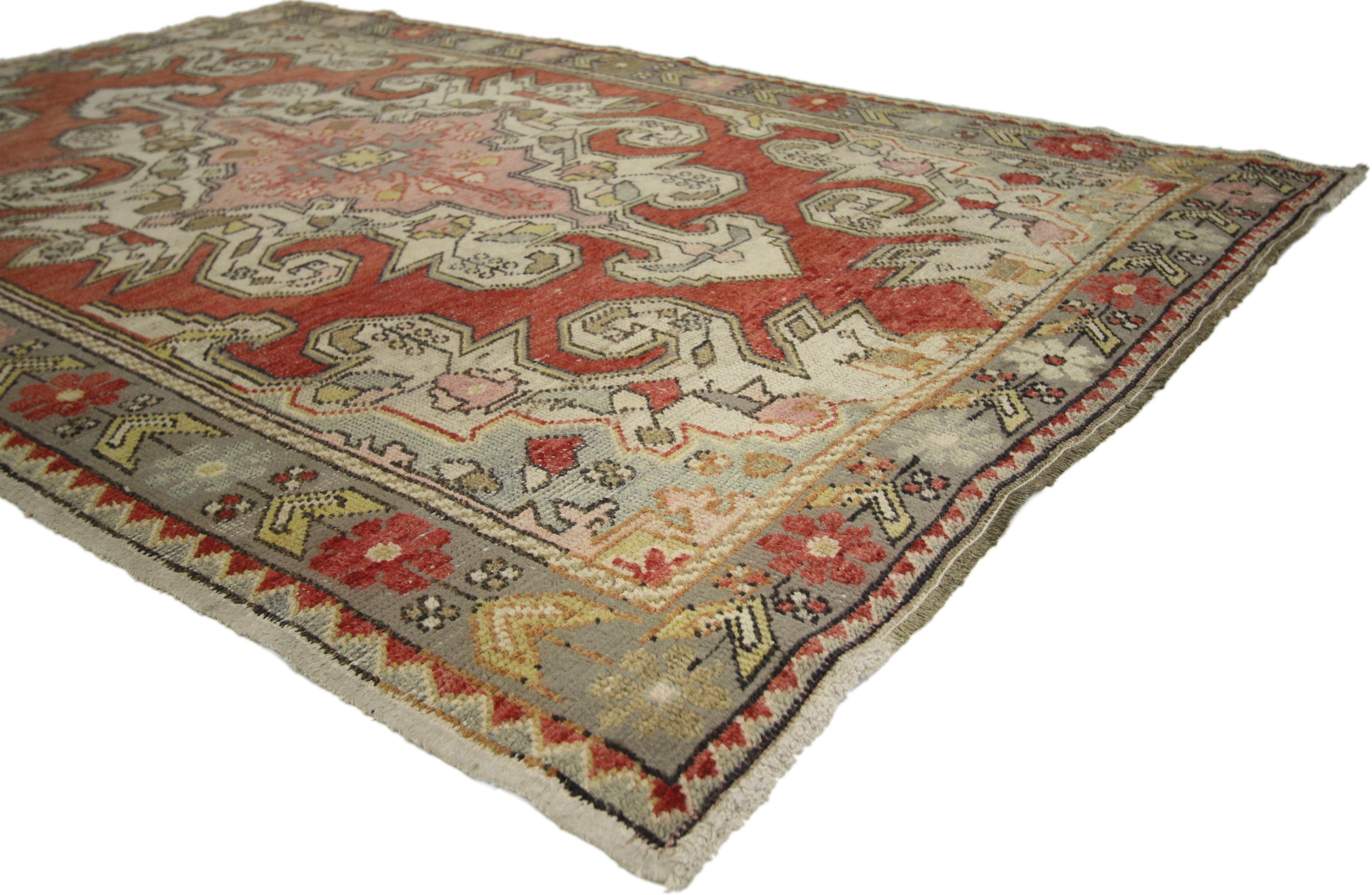 50057 A vintage Turkish Oushak accent rug in all-over floral design. This opulent vintage Turkish Oushak rug features an angular floral design similar to the Persian styles. A pink medallion is framed in an ornate cream and bordered in sage on an