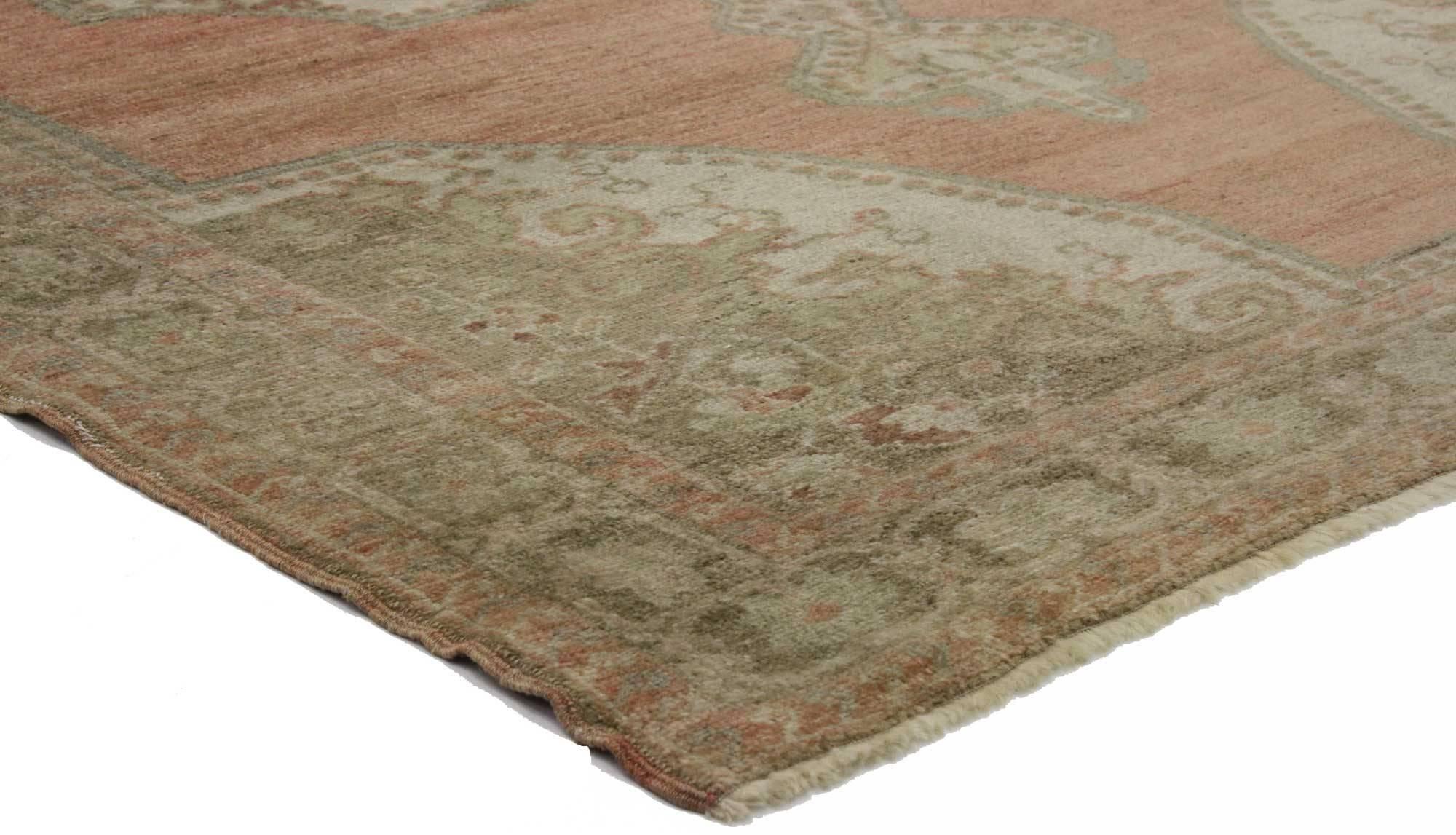 74743, a vintage Turkish Oushak accent rug. This traditional style Turkish Oushak accent rug features a large-scale, ornate central medallion. The medallion is flanked with two cartouche finials and floats in a sea of rich abrashed waves. Spandrels