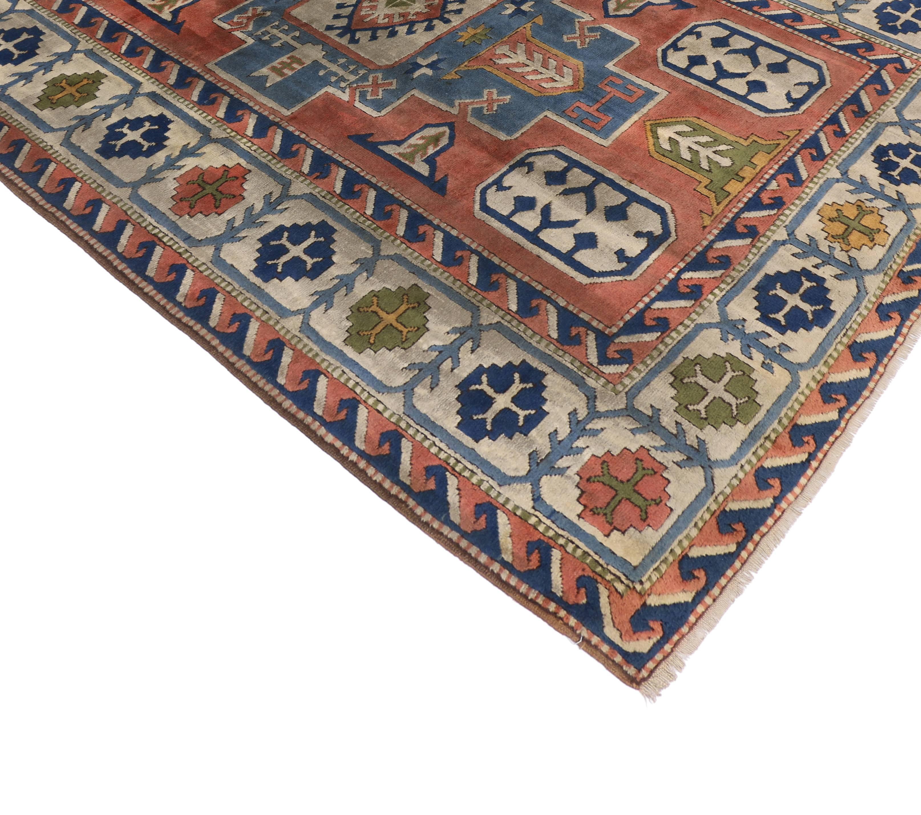 74752, vintage Turkish Oushak area rug. This hand-knotted wool vintage Turkish Oushak rug with tribal style features a central amulet with a Turkish gul on a sky blue field dotted with stars, arrows and Caucasian style tribal symbols. The large