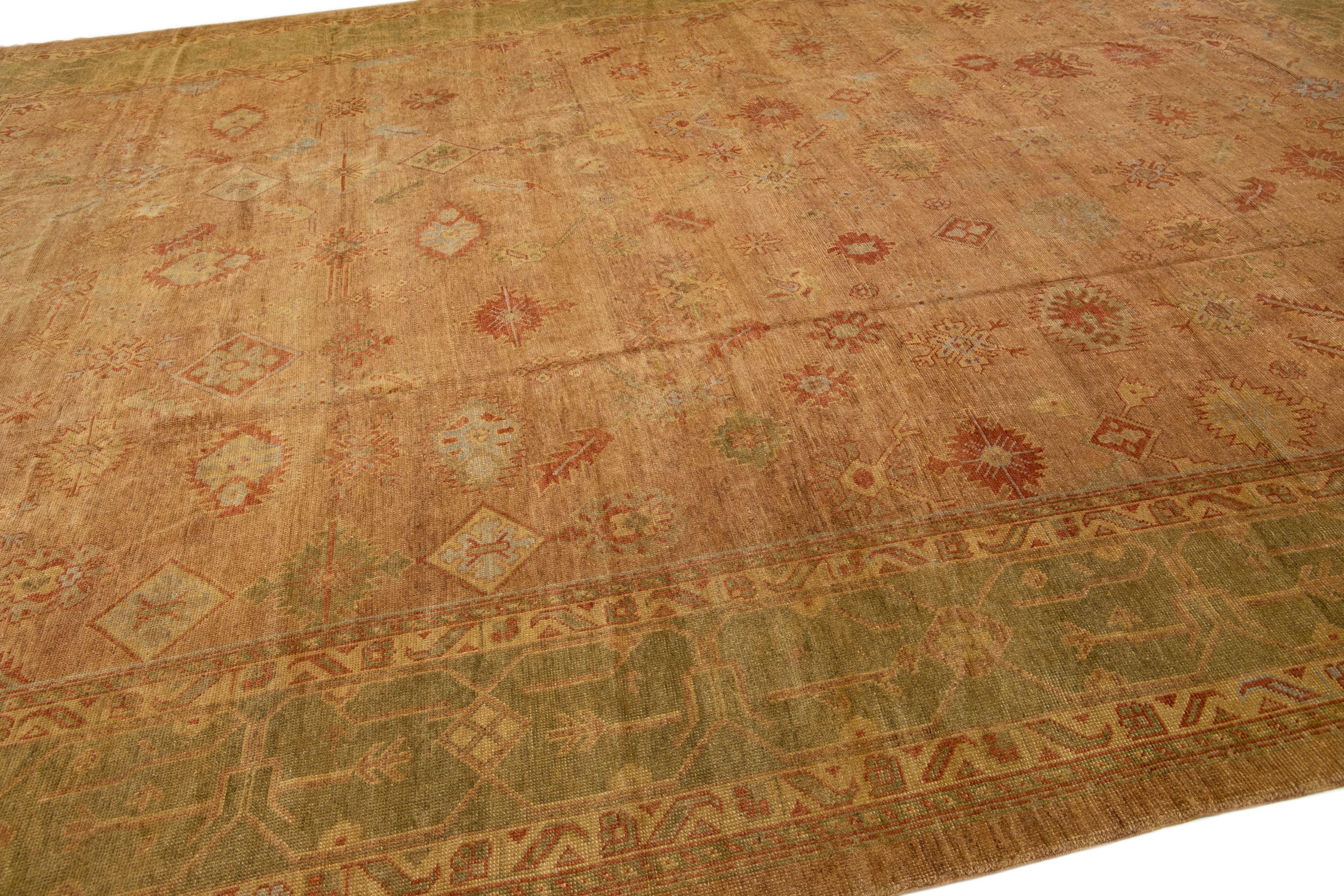 Beautiful Vintage Turkish Oushak hand-knotted wool rug with a brown color field. This rug has green and rust accents in a gorgeous large-scale floral pattern.

This rug measures: 14'4