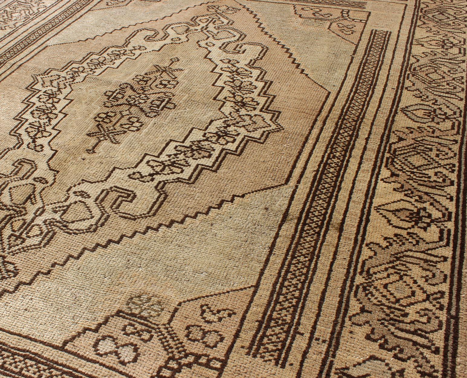 20th Century Vintage Turkish Oushak Carpet with Stylized Design in Brown, Cream, and Tan For Sale