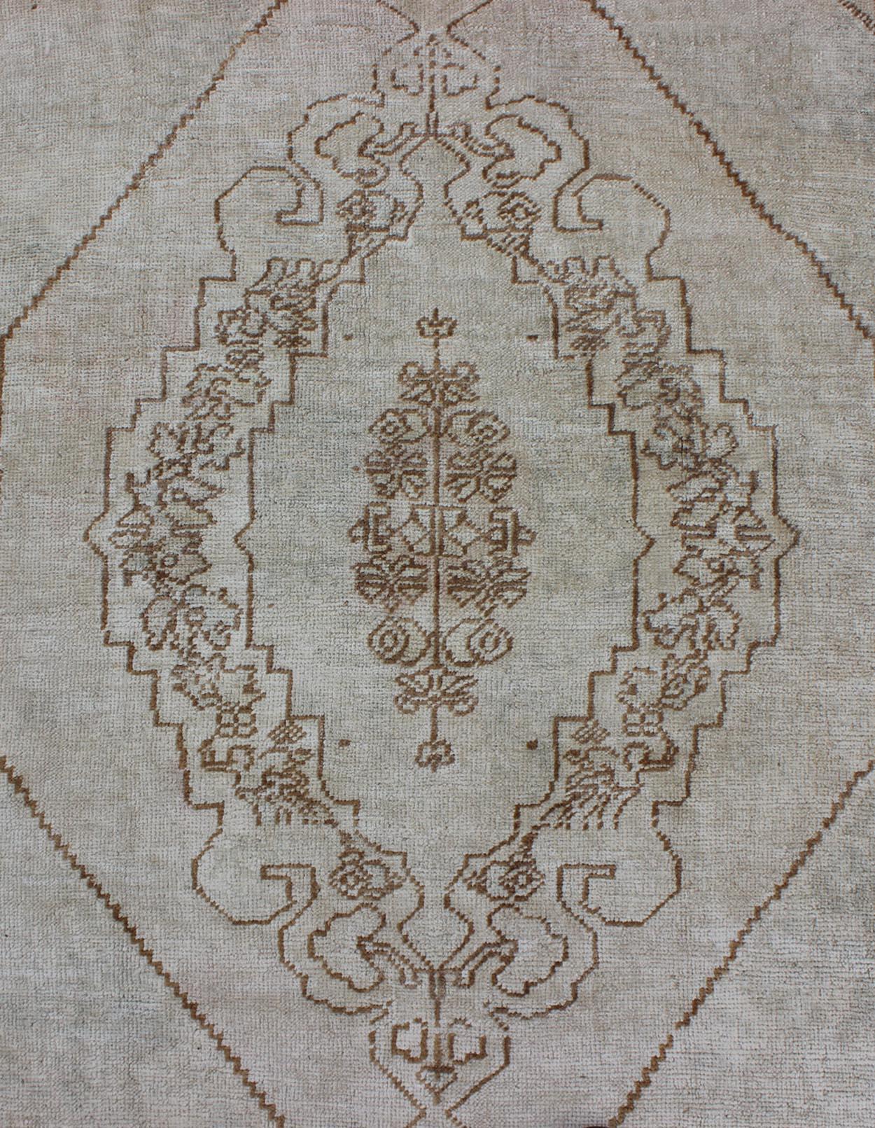 Mid-20th Century Vintage Turkish Oushak Carpet with Floral Medallion Design in Neutral Tones For Sale