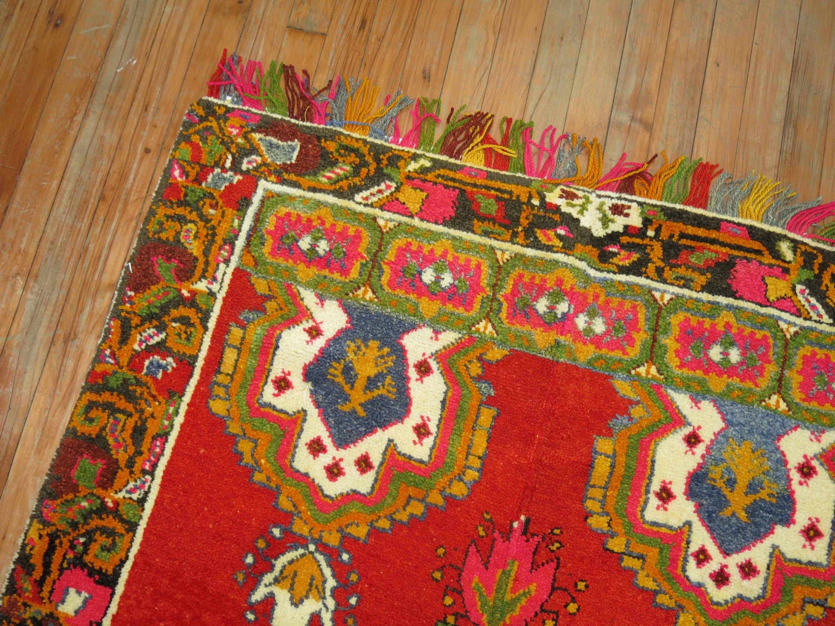 A mid-20th century Turkish rug featuring bright intense colors and wild fringes.

3'9'' x 5'7''


