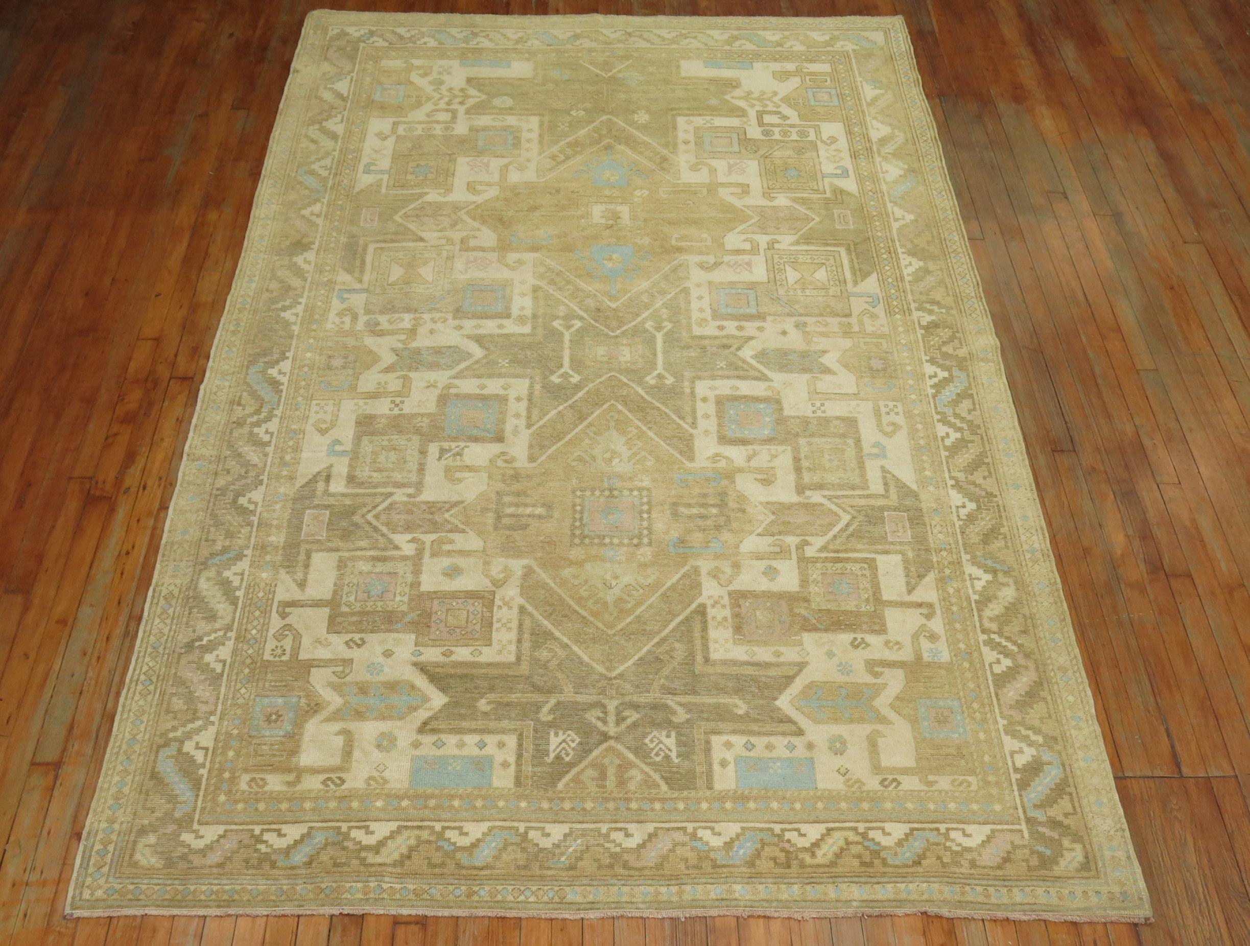 Mid-20th century Oushak with a motif derived from 19th century Caucasian carpets. Nice warm colors, accents in ivory, brown and light blue.
