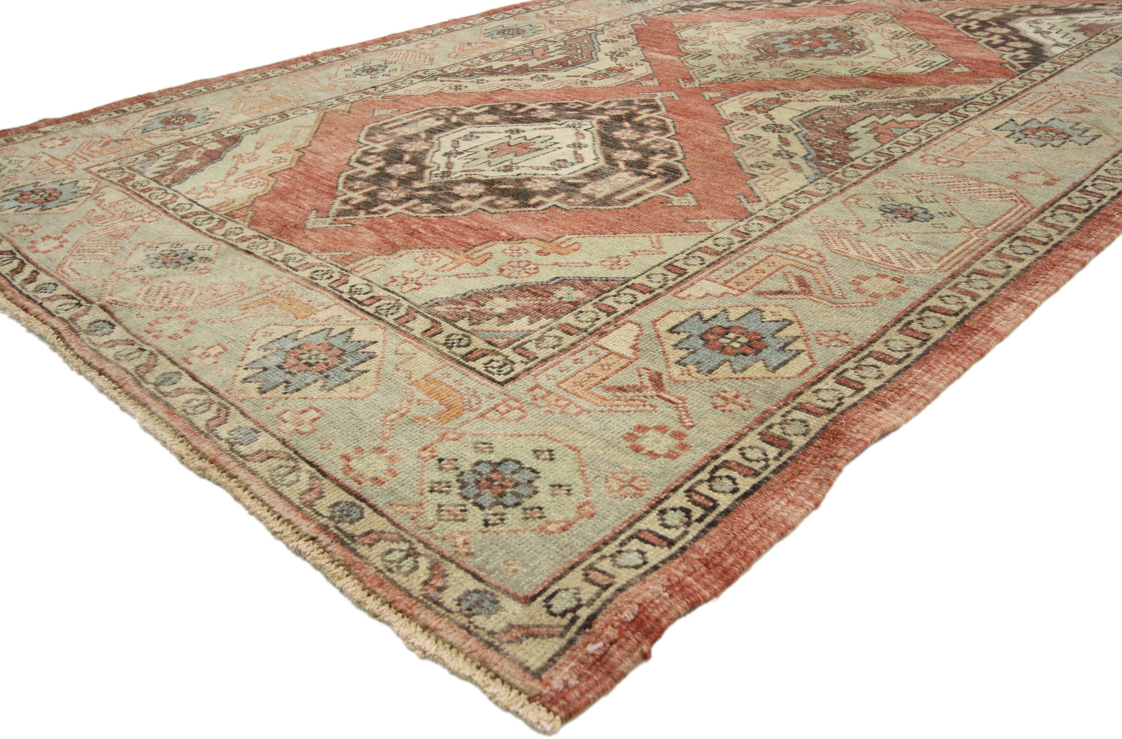 52415 Vintage Turkish Oushak Rug, 04'09 x 11'03. Immerse yourself in the allure of this hand-knotted masterpiece – a vintage Turkish Oushak gallery rug that weaves a tale of timeless elegance. Picture a canvas adorned with four lozenge medallions,