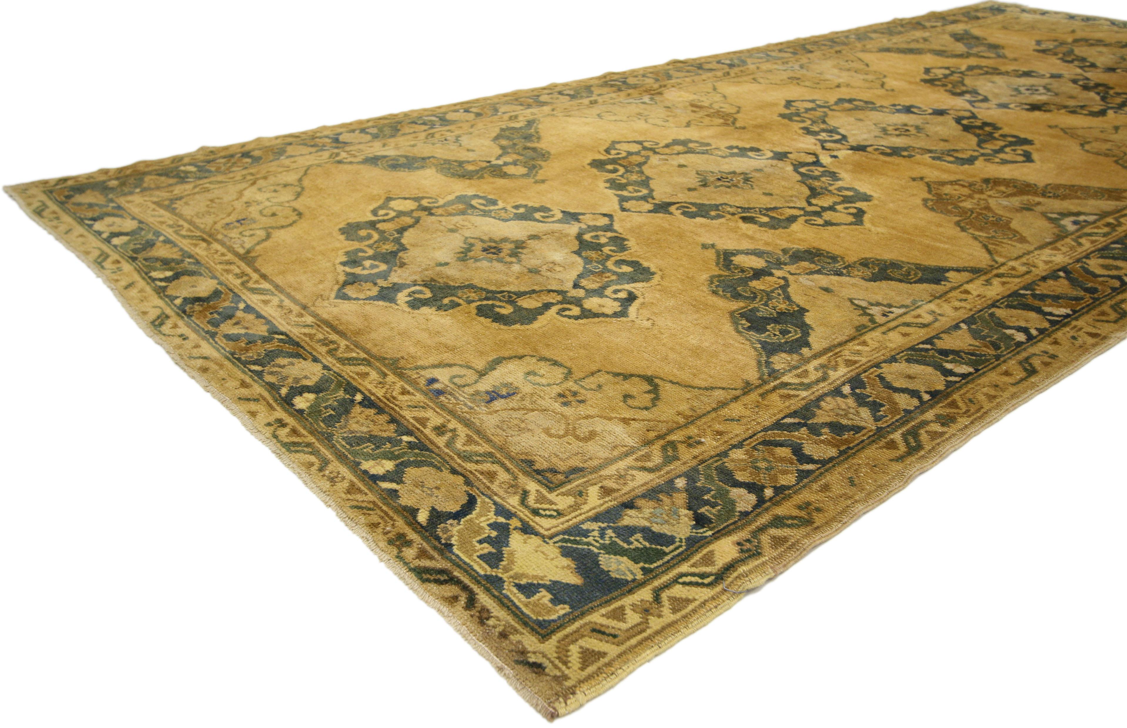 50004, vintage Turkish Oushak Gallery rug with neoclassic style, wide hallway runner. Elegant and captivating, this hand knotted wool vintage Turkish Oushak gallery rug features five Chinese Cloud collar medallions. Four half trefoil ziggurats