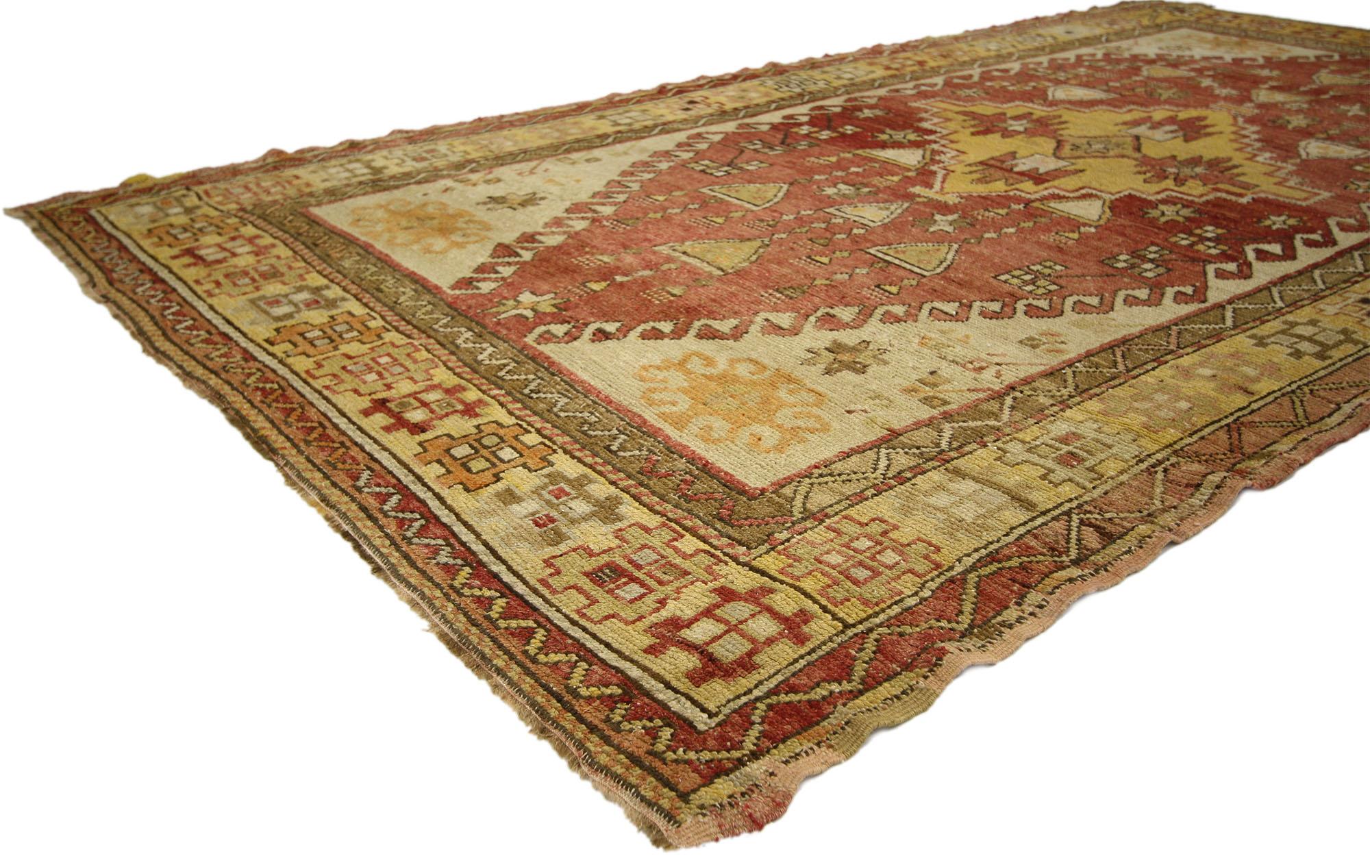 73937, vintage Turkish Oushak gallery rug with rustic tribal style. With warm terracotta hues and rustic sensibility, this hand knotted vintage Turkish Oushak rug is well-balanced and poised to impress. Taking central stage is a stepped diamond