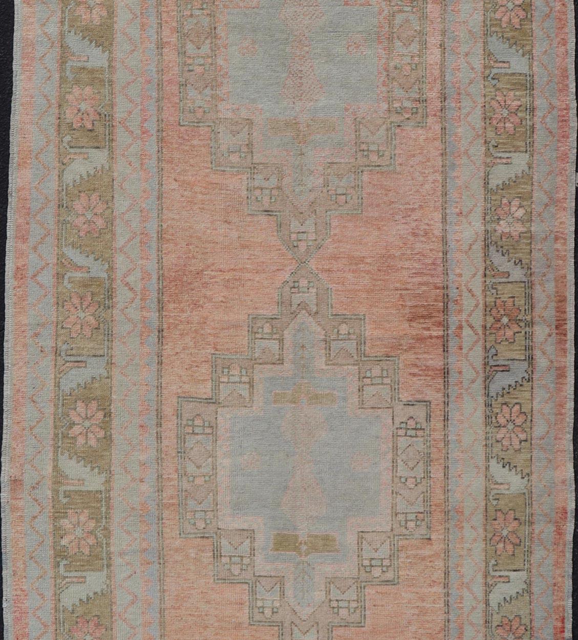20th Century Vintage Turkish Oushak Gallery with Tribal Medallions in Soft Peach and Green For Sale