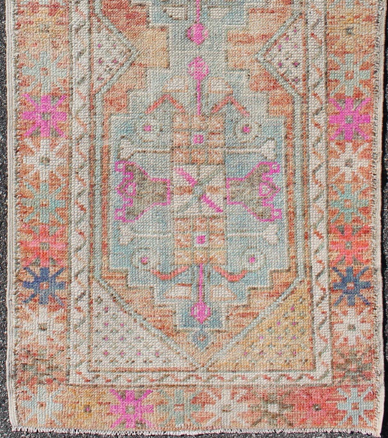 Oushak vintage rug from Turkey with multicolored Medallion design, colors include Orange, Purple/lavender, pink, green, light blue rug en-165996, country of origin / type: Turkey / Oushak, circa 1930

This vintage Turkish Oushak rug features a