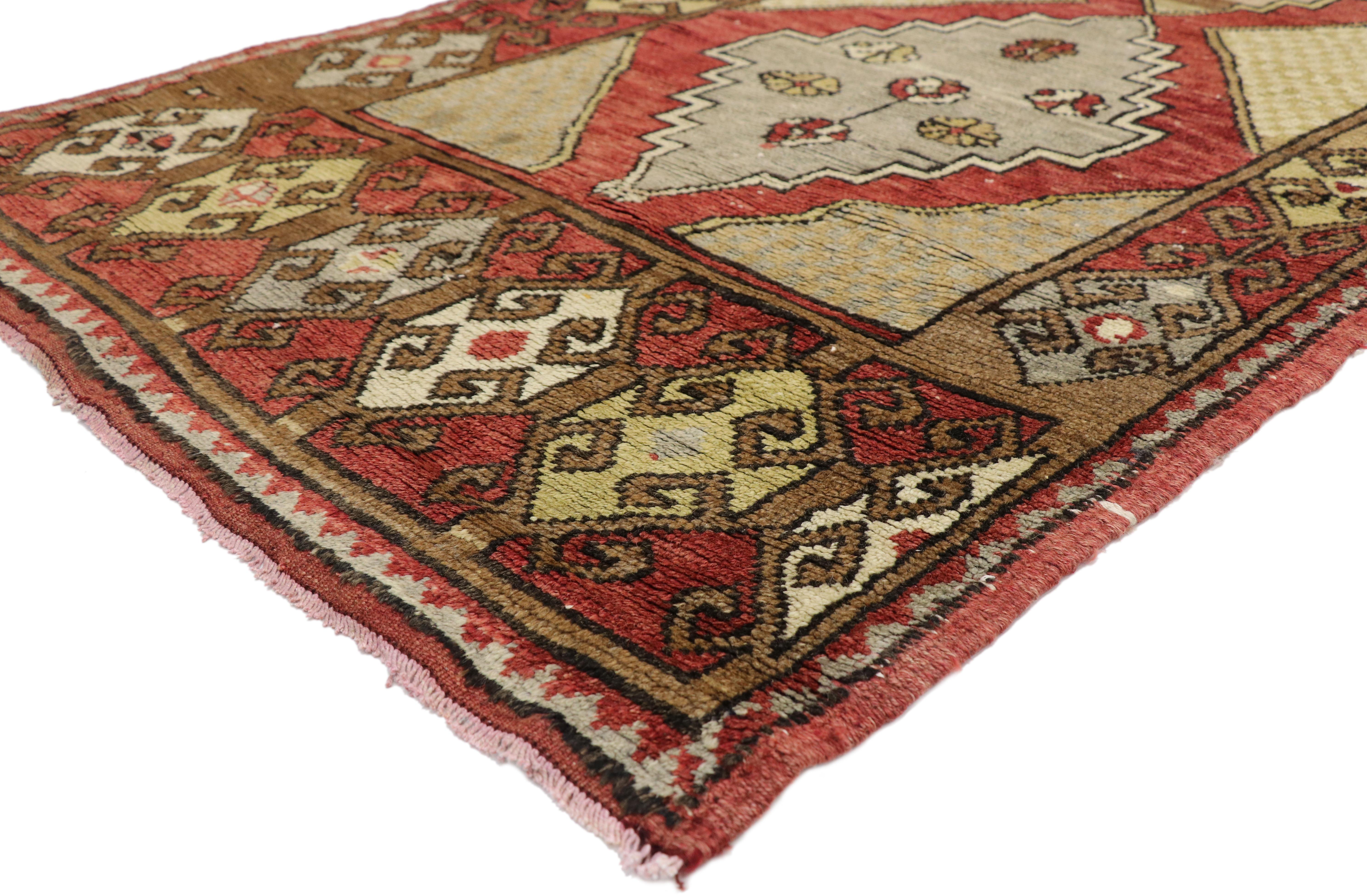 52403 Vintage Turkish Oushak Hallway Runner 03'09 x 11'01. This hand-knotted wool vintage Turkish Oushak runner features three stepped lozenge medallions floating on an abrashed field. Each medallion is dotted with a variety of multicolored