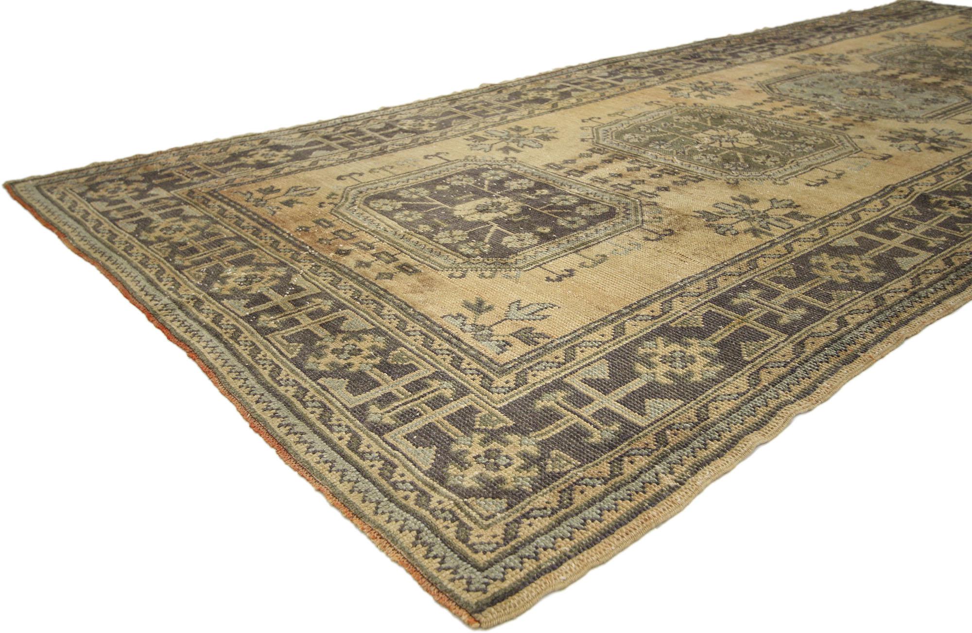 51143, vintage Turkish Oushak Hallway runner with Gustavian or French Country style. This hand knotted wool vintage Turkish Oushak runner features five amulet medallions filled with roundels and floral sprays floating on an abrashed ecru field