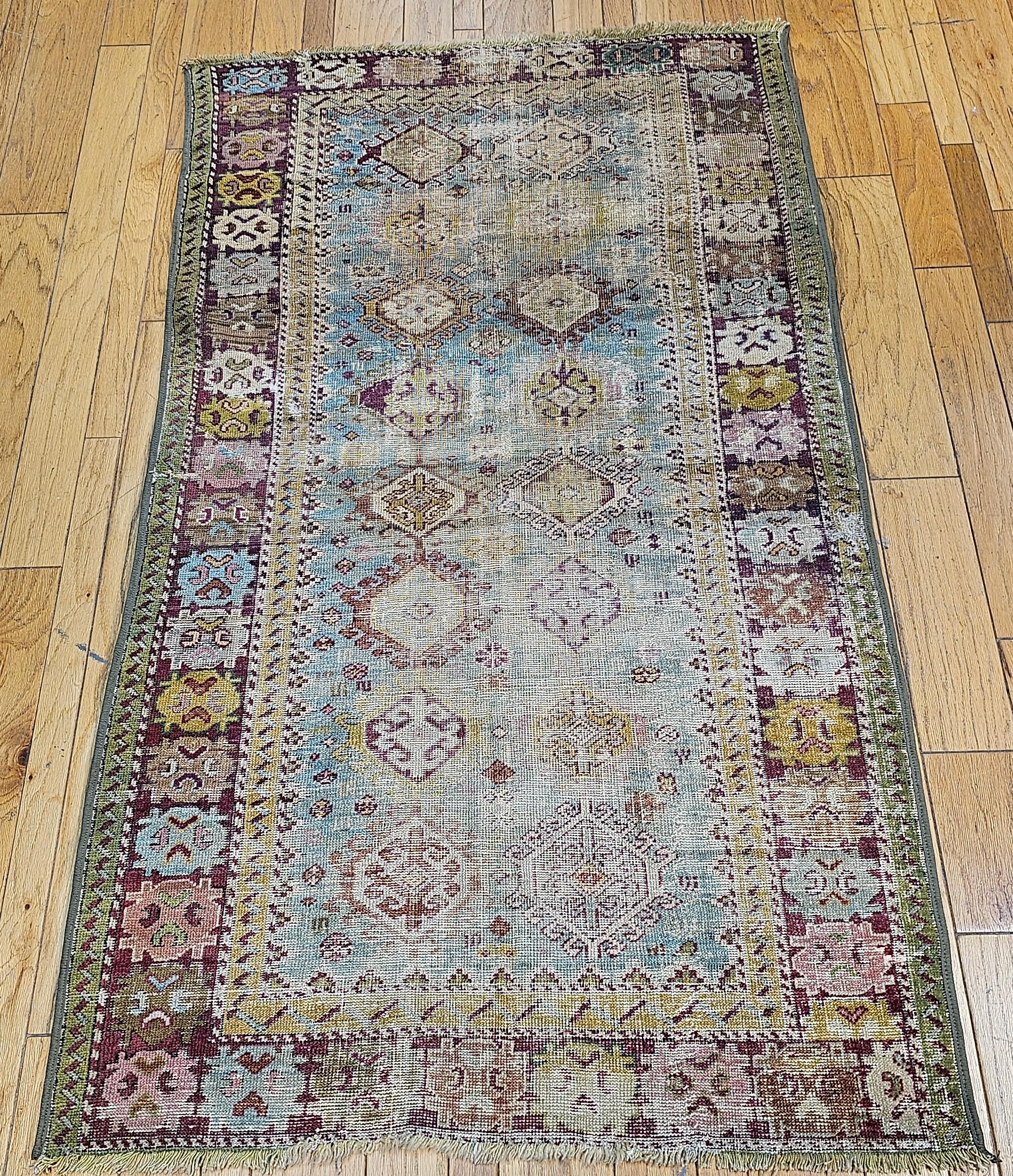 Beautiful and colorful “distressed” Caucasian Karabagh from the 4th quarter of the 1800s.  The Karabagh area rug was artistically woven and is in blue/turquoise background color with design accent colors, green, and cranberry red, yellow, and brown.