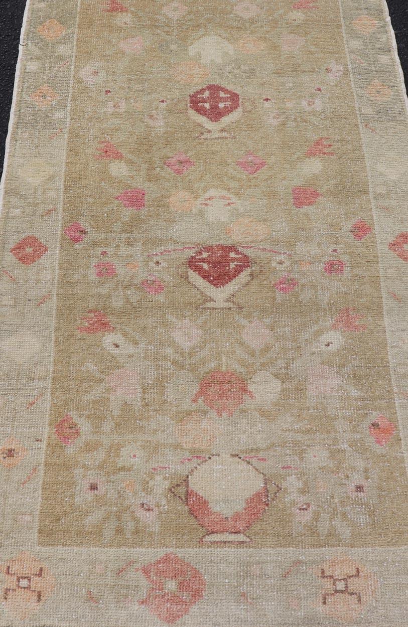 Turkish Oushak Carpet with Colorful Floral Designs Set on Sand-Green Field. Angora Turkish Oushak Carpet Antique, Keivan oven Arts/rug EN-178785, country of origin / type: Turkey / Oushak, circa mid-20th Century.
Measures: 2'8 x 4'9 
This Oushak