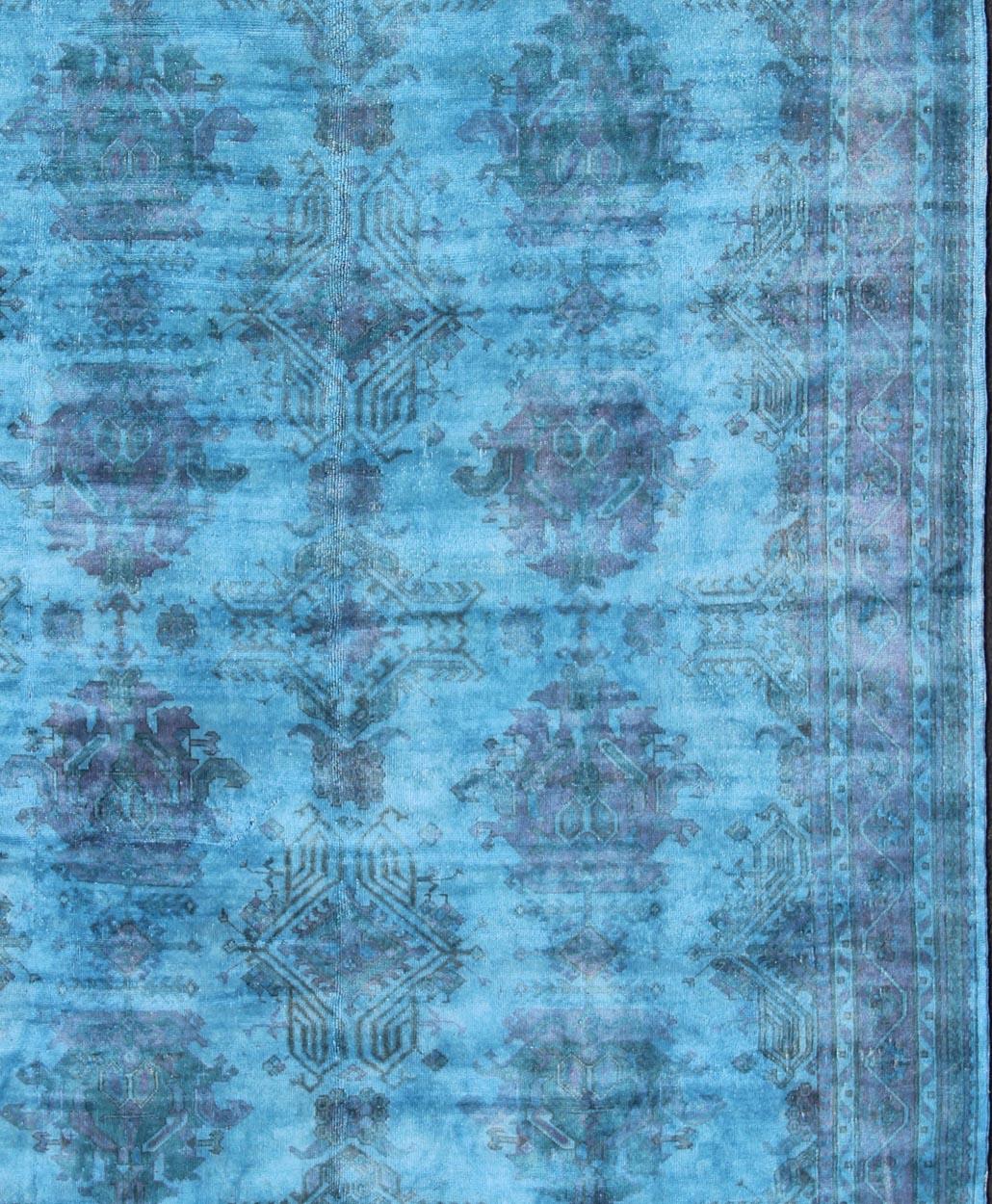This vintage Turkish carpet with a classical composition has been overdyed with blue, light blue and pink pigments. With both classic and contemporary characteristics, this beautiful carpet could perfectly adorn a transitional or a contemporary
