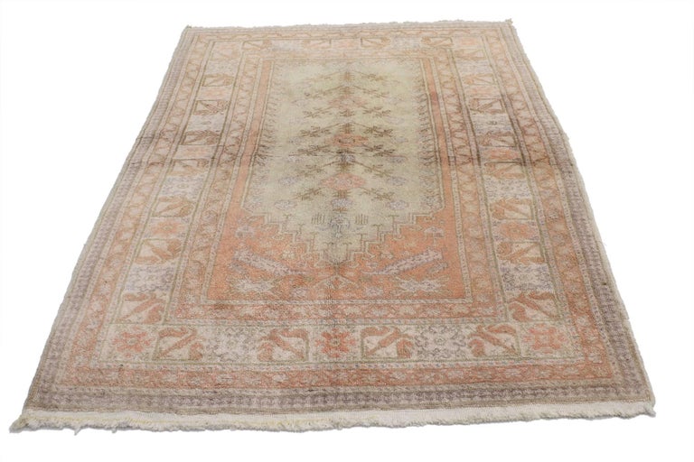 52094, vintage Turkish Oushak Prayer rug, Anatolian Prayer rug. This hand knotted wool vintage Turkish Oushak prayer rug features a stepped Mihrab prayer niche design with a central tree of life motif spread across a minty light green-gray field.