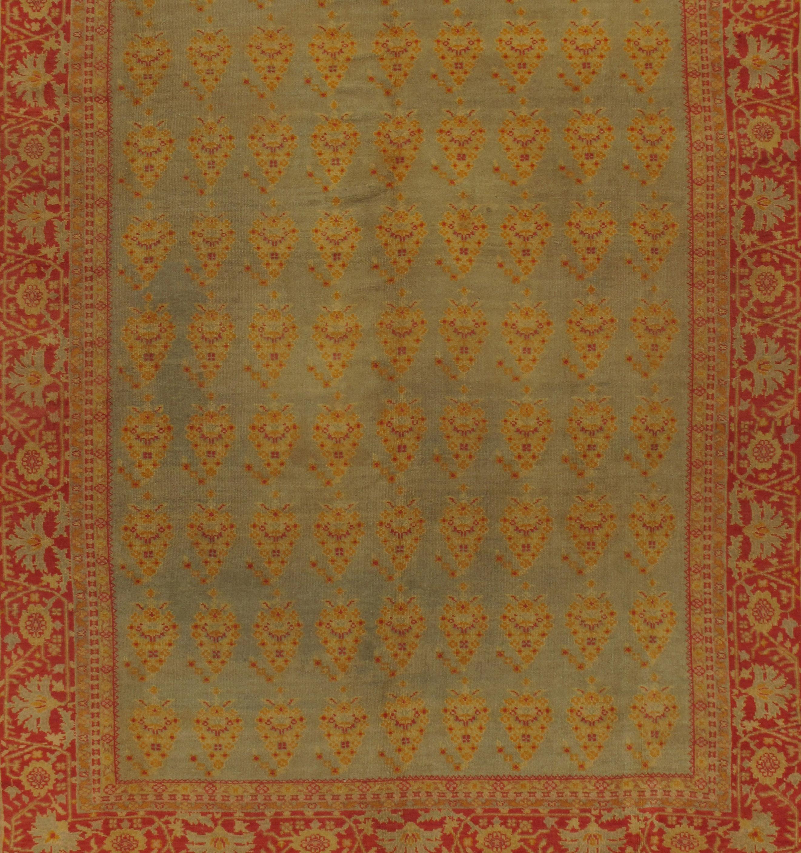 Vintage Turkish Oushak rug carpet, circa 1940 9'4 x 11'10. The soft colors in the field which is filled with repeating floral motifs is surrounded by a main border in soft reds to create a rug that has harmony in this antique Turkish Oushak.