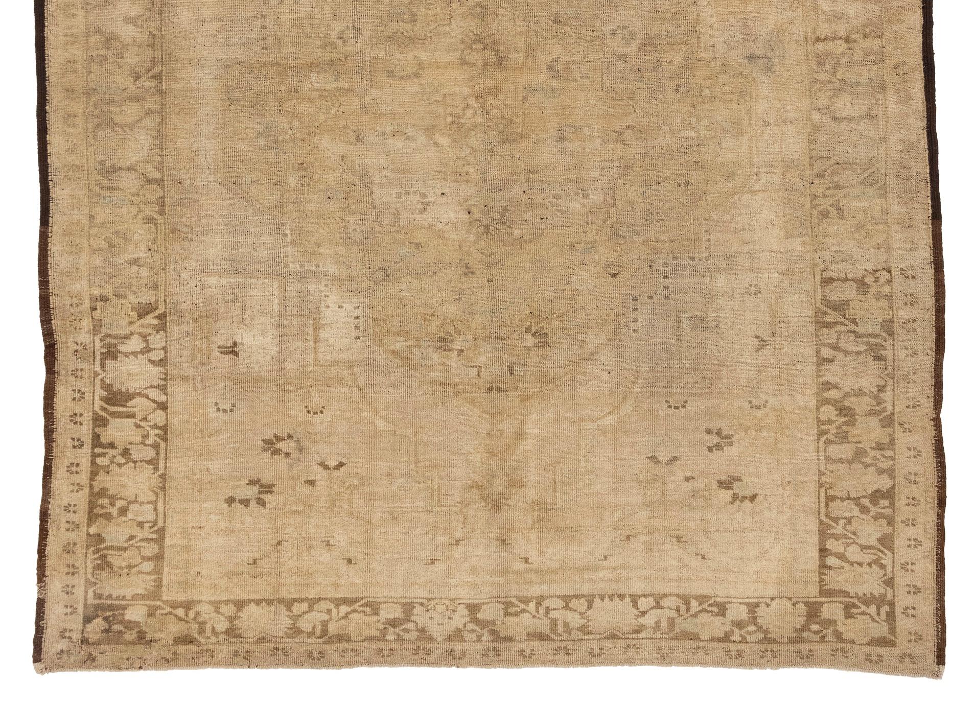 Vintage Oushak rugs are a type of handwoven rug that originated in Turkey. These rugs are known for their soft, muted color palettes, with beige and tan being particularly popular shades. Vintage Oushak rugs are prized for their fine craftsmanship,
