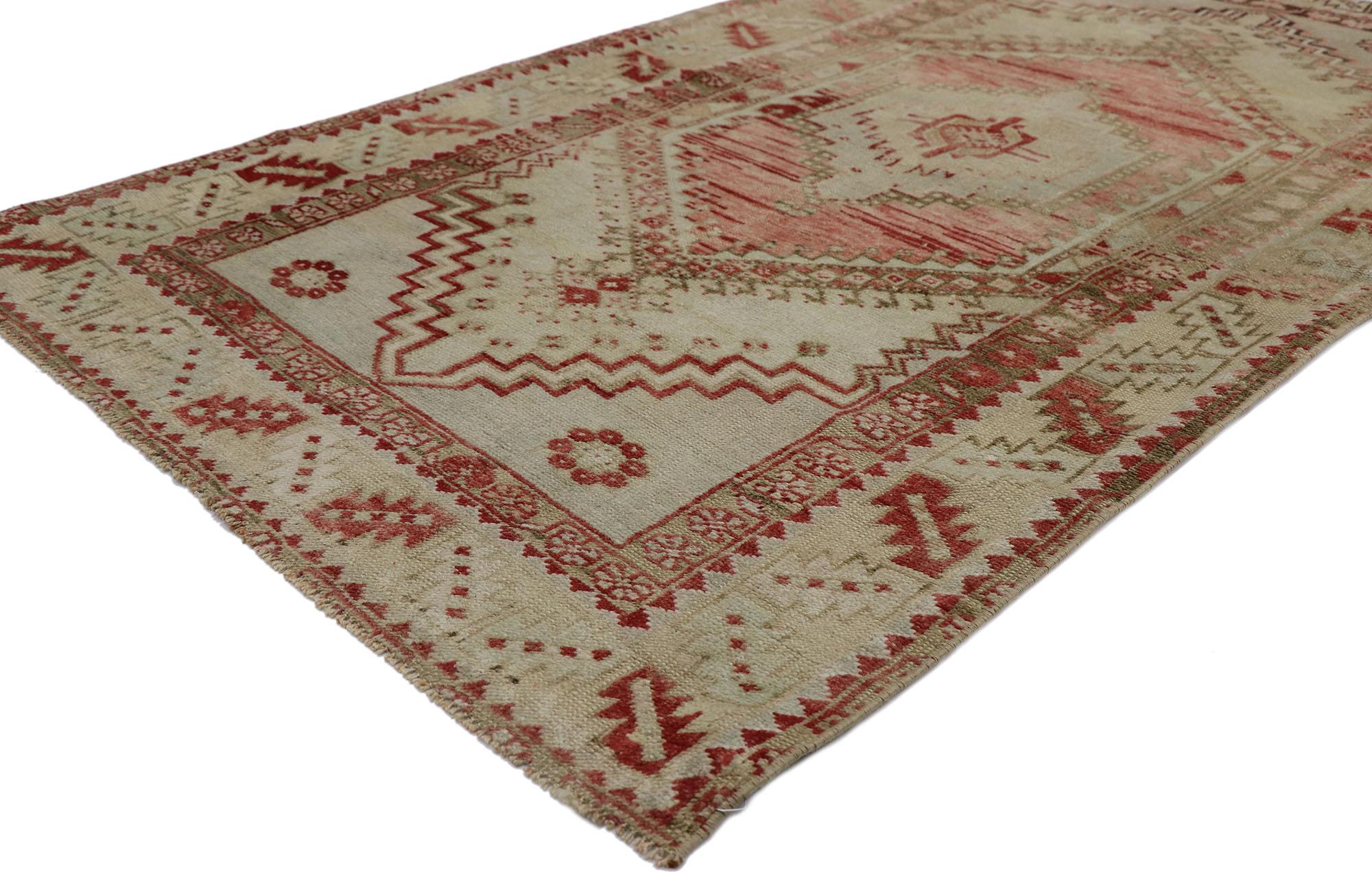 53571 Vintage Turkish Oushak rug 03'03 x 05'06. With its beguiling beauty and rustic sensibility, this hand-knotted wool vintage Turkish Oushak rug is immersed in Anatolian history. The abrashed cut-out field features a concentric stepped medallion
