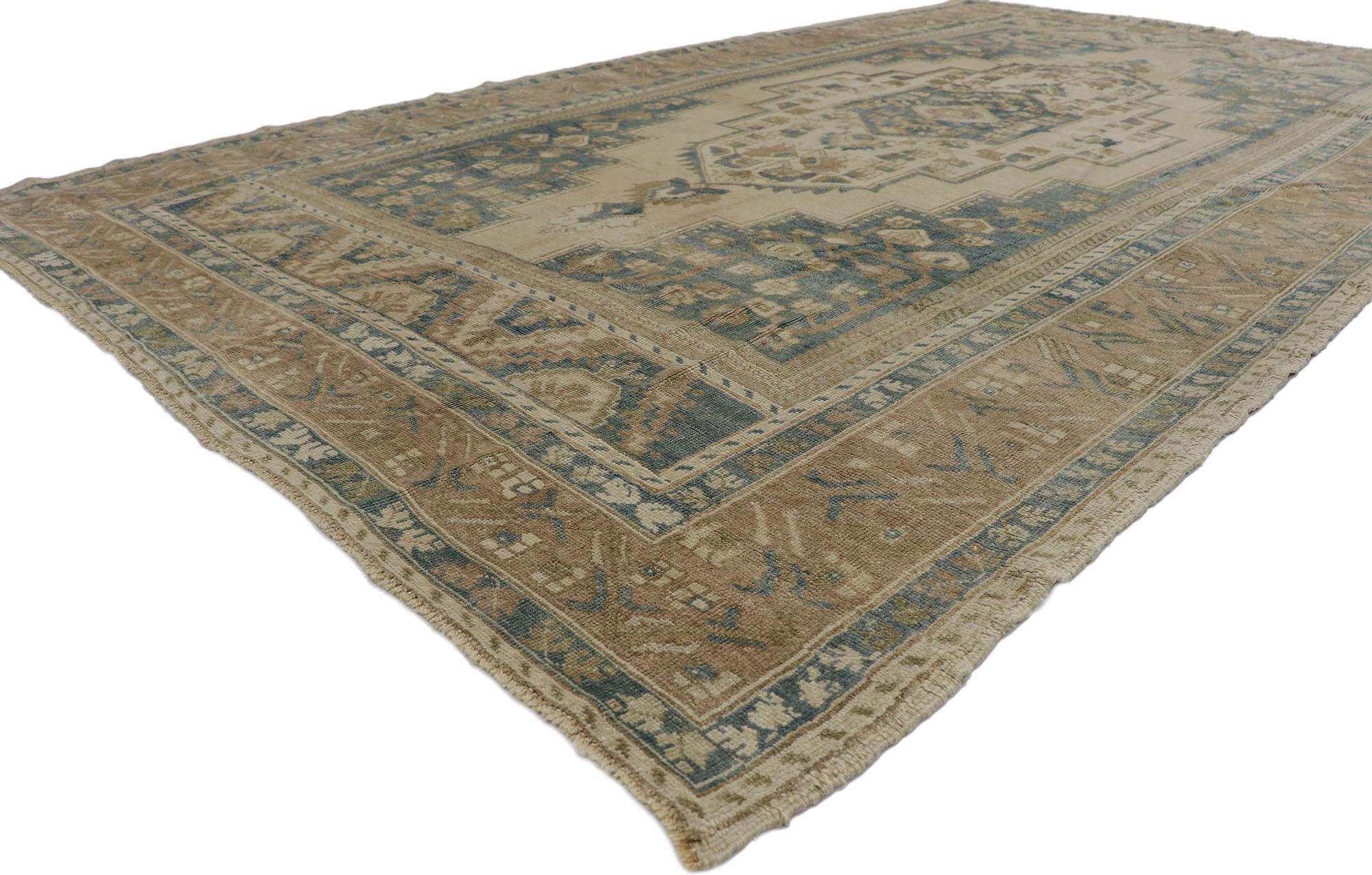 53621 Vintage Turkish Oushak rug 06'08 x 11'02. Effortless beauty and simplicity meet soft, bespoke vibes with Mid-Century Modern style in this hand-knotted wool vintage Turkish Oushak rug. The antique washed cut-out field features a stepped