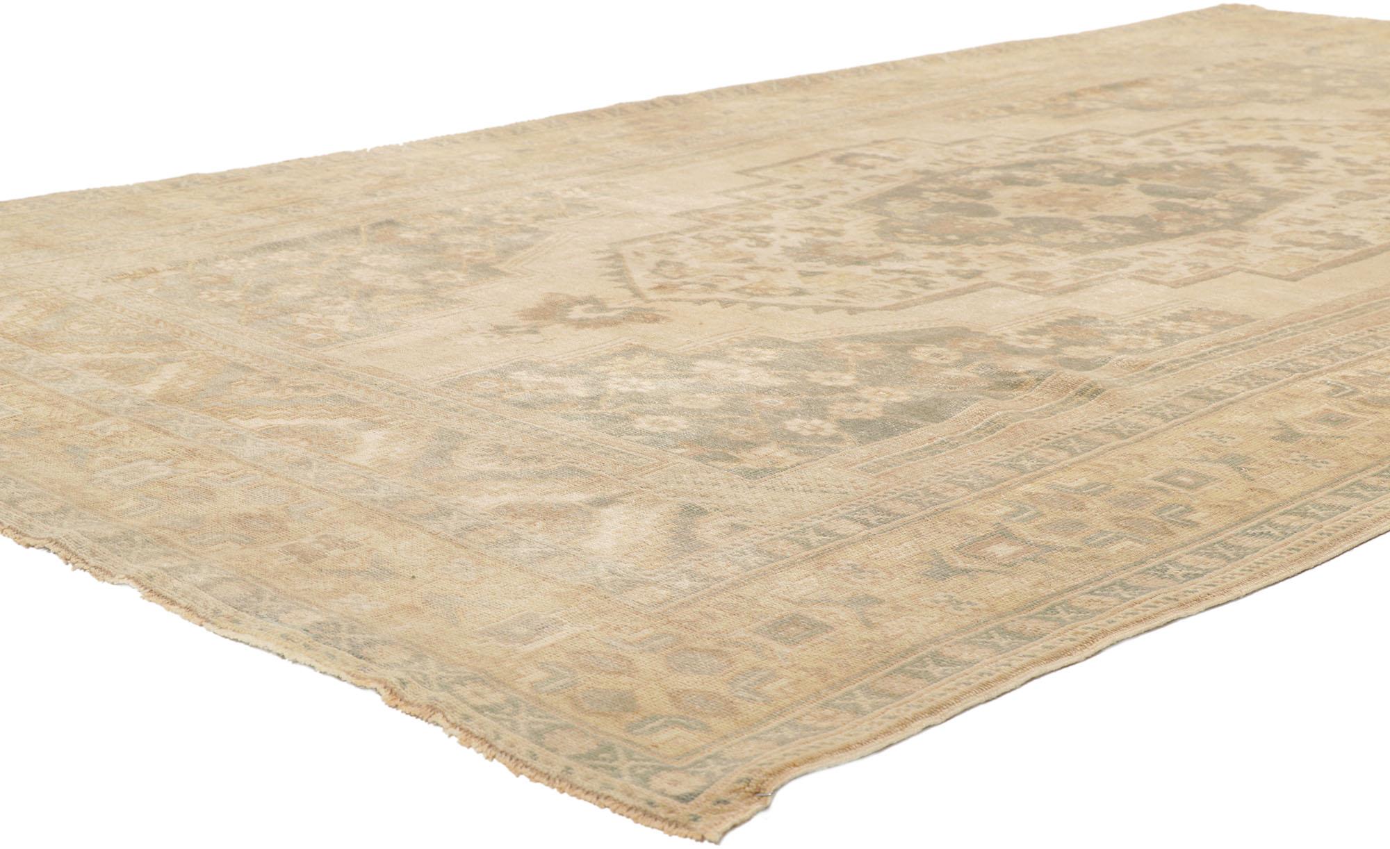 53687 Vintage Turkish Oushak rug 5'08 x 9'07. Showcasing effortless beauty and soft, bespoke vibes, this hand knotted wool vintage Turkish Oushak rug beautifully embodies romantic cottage style. The antique washed field features a central medallion