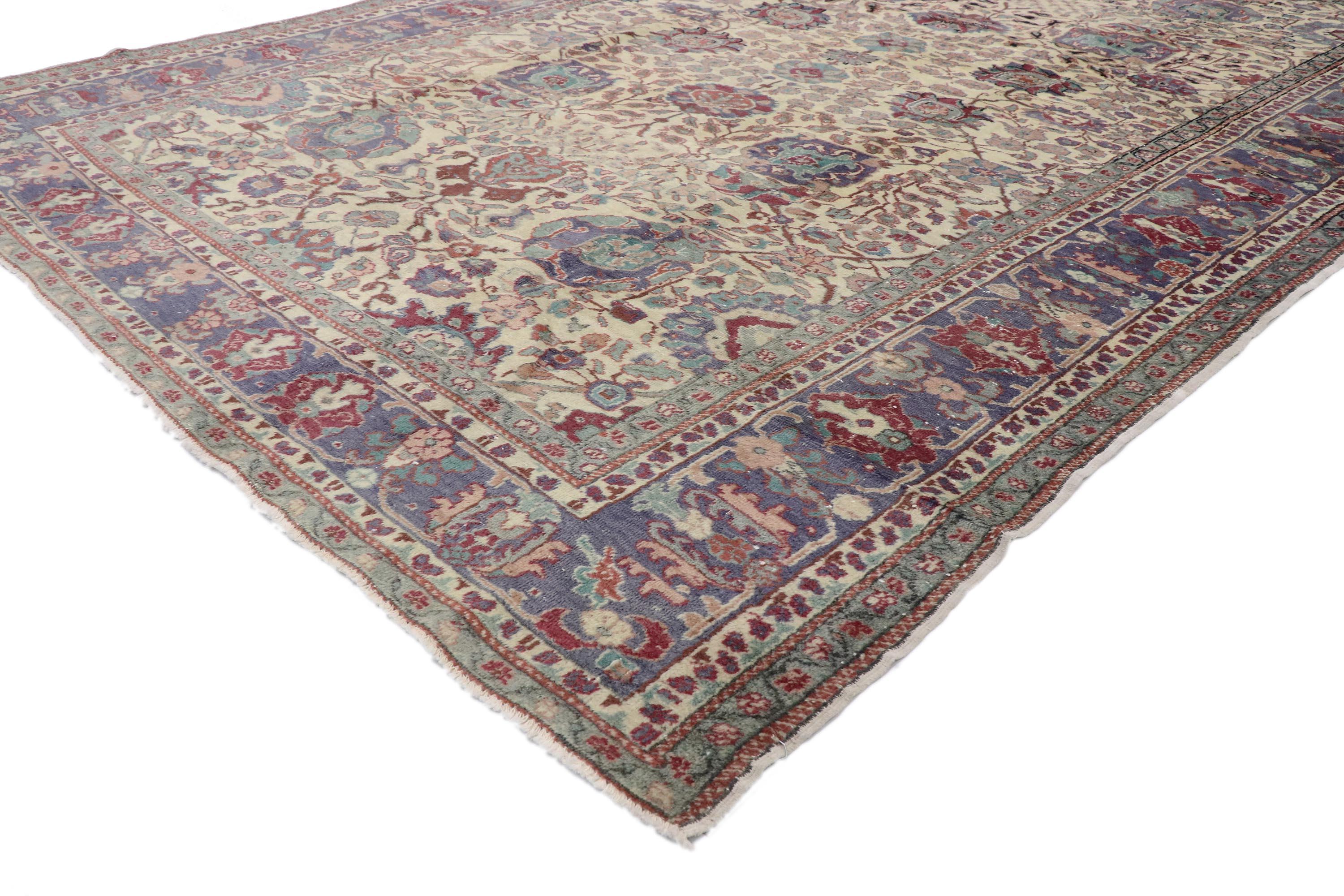 With its timeless style, incredible detail and texture, this hand knotted wool vintage Turkish Oushak rug is a captivating vision of woven beauty. The eye-catching botanical design and sophisticated colorway woven into this piece work together
