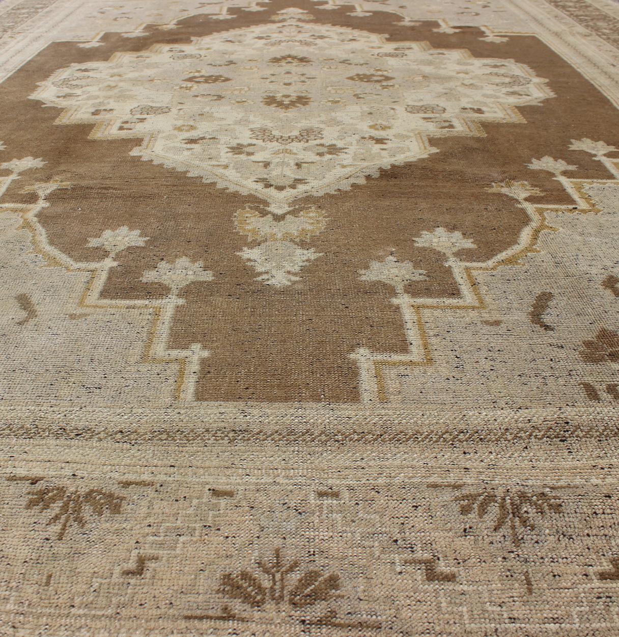 20th Century Vintage Turkish Oushak Rug in Brown Background and Neutral Colors For Sale