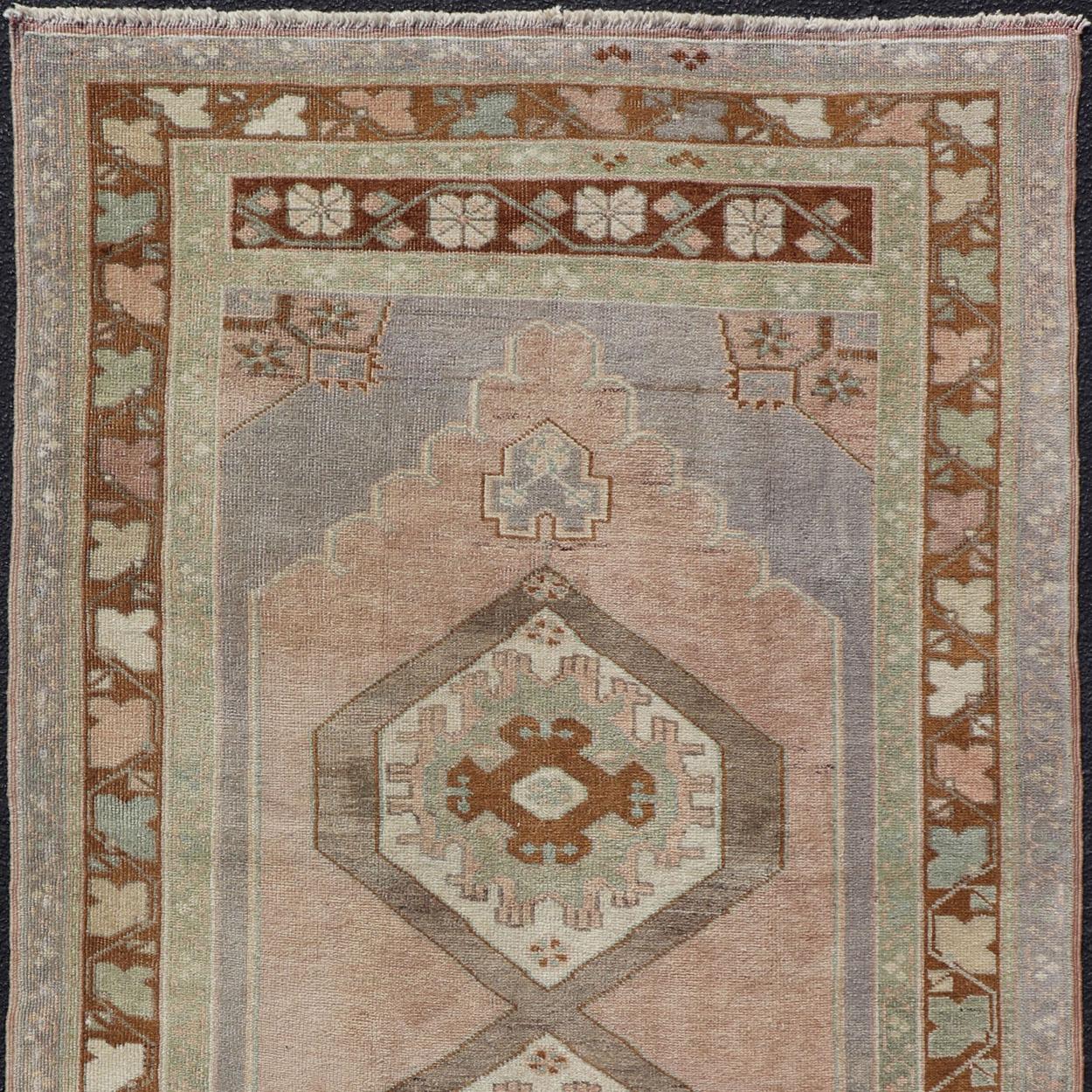 Midcentury Turkish Oushak rug with diamond medallions in lavender, pink, brown, cream and blue rug TU-NED-1023, country of origin / type: Turkey / Oushak, circa 1950.

This beautiful vintage Oushak runner from 1950s Turkey features a geometric