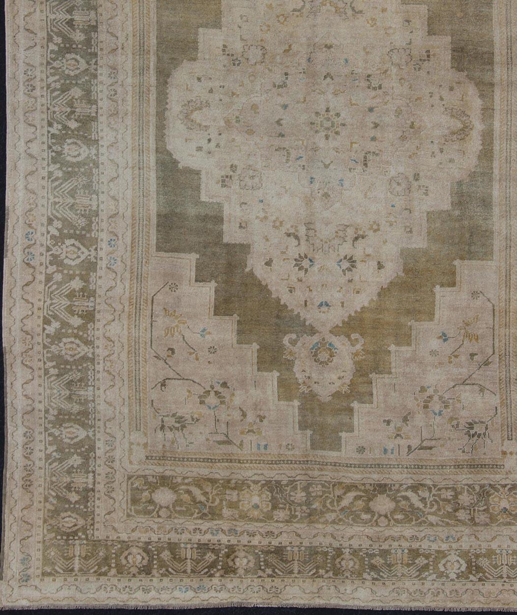  Beautiful and unique color Turkish Oushak vintage in Olive and Army green background and border, and  soft tones of tan. taupe, blush yellow and teal. rug en-179178, country of origin / type: Turkey / Oushak, circa 1940

This Oushak rug from Turkey
