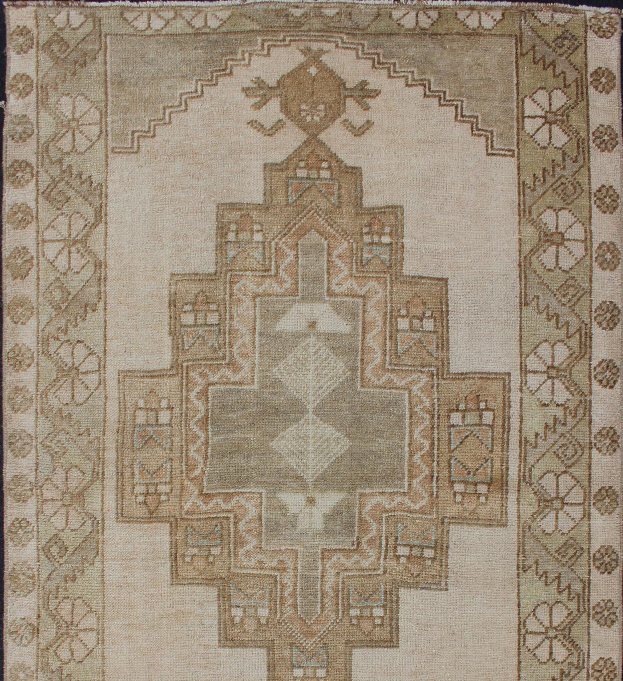 Vintage oushak from Turkey with Medallion design in various tones of green, tan, sand, taupe and light green rug EN-176671, country of origin / type: Turkey / oushak, circa 1940. 
This beautiful vintage Oushak rug from 1940s Turkey features a