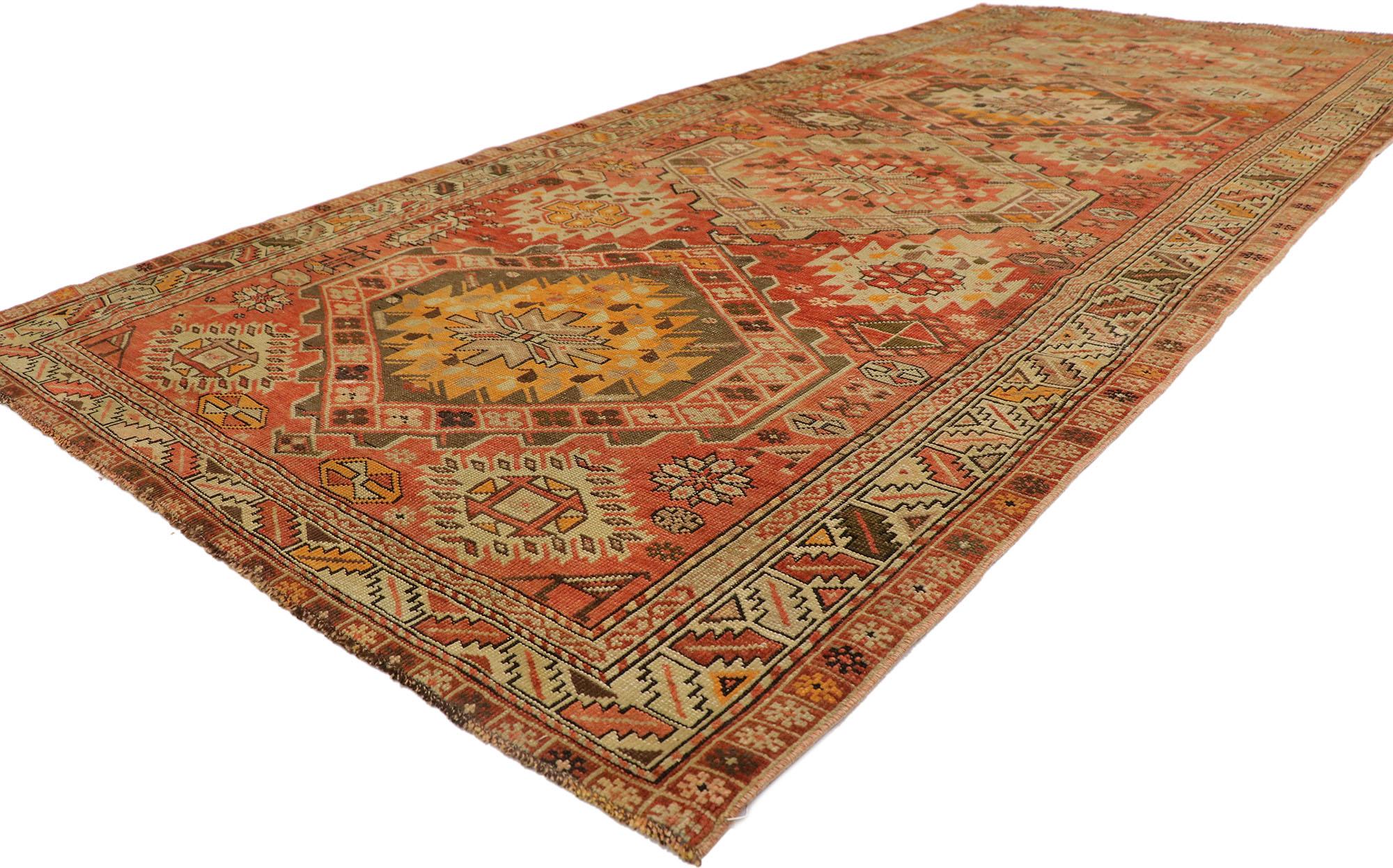 ​53655 Vintage Turkish Oushak Rug, 04'09 x 10'02.
​Behold the nomadic enchantment and tribal flair imbued in this hand knotted wool vintage Turkish Oushak rug. Its woven splendor showcases a mesmerizing geometric pattern and bold earthy color