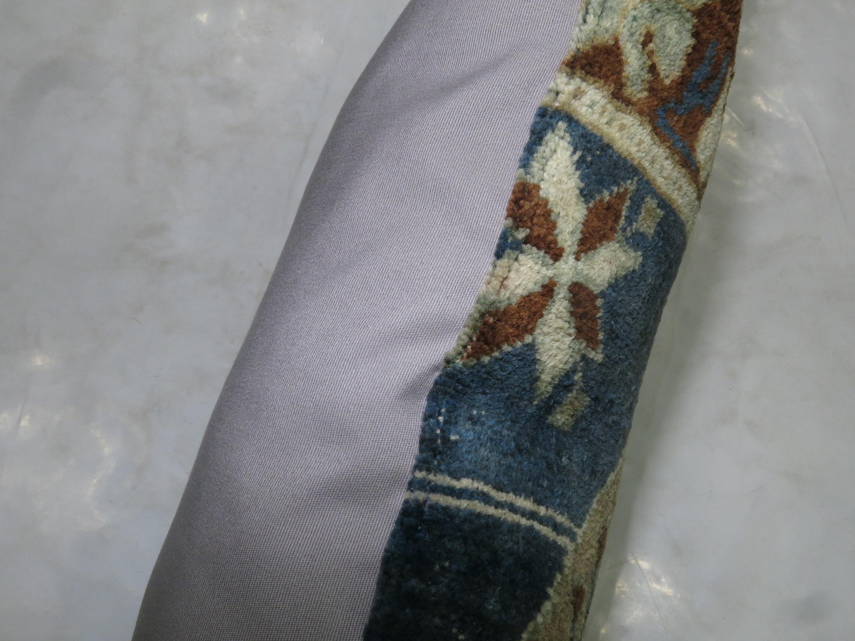 Pillow made from a vintage Turkish Oushak rug with pops of blue gray.

17'' x 22''