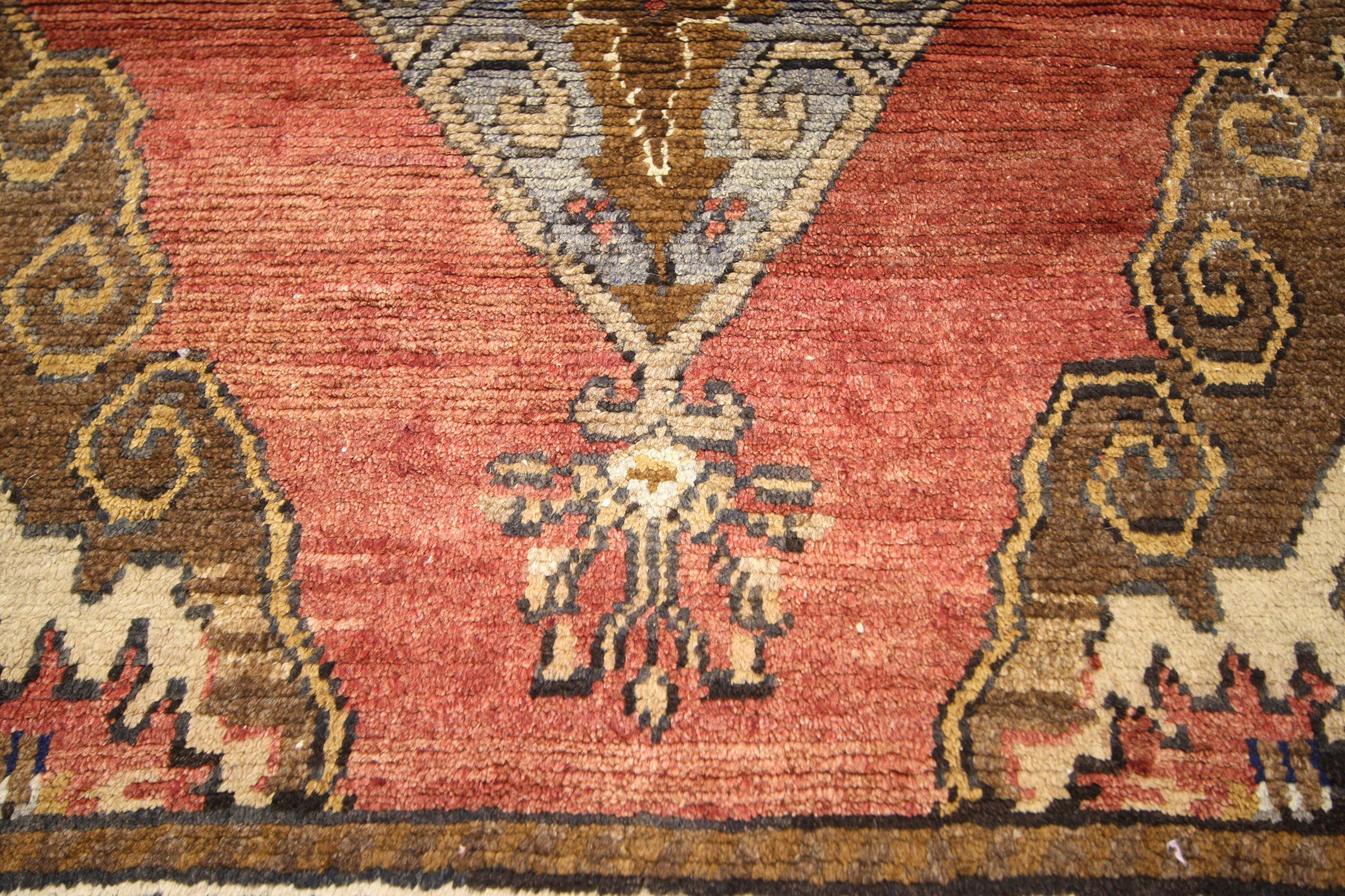 50228 a vintage Oushak rug runner. Punctuate your space with personality by incorporating this vintage Oushak runner. It features two substantial yet intricate medallions of tan and dark gray each enclose with geometric symbols in brown hues of