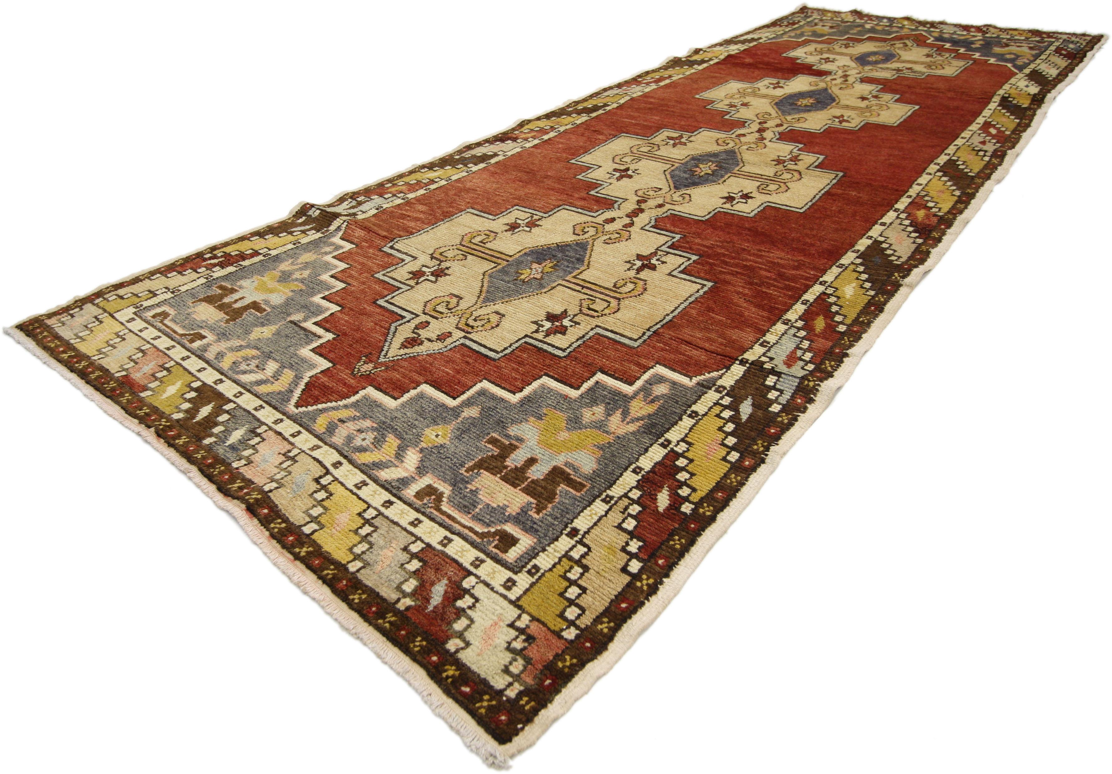 50179 Vintage Turkish Oushak Runner with Mid-Century Modern Style. This hand-knotted wool vintage Turkish Oushak runner features four large gul amulets patterned with diamonds, Ram's Horn, and eight-point stars. Each corner spandrel is filled with