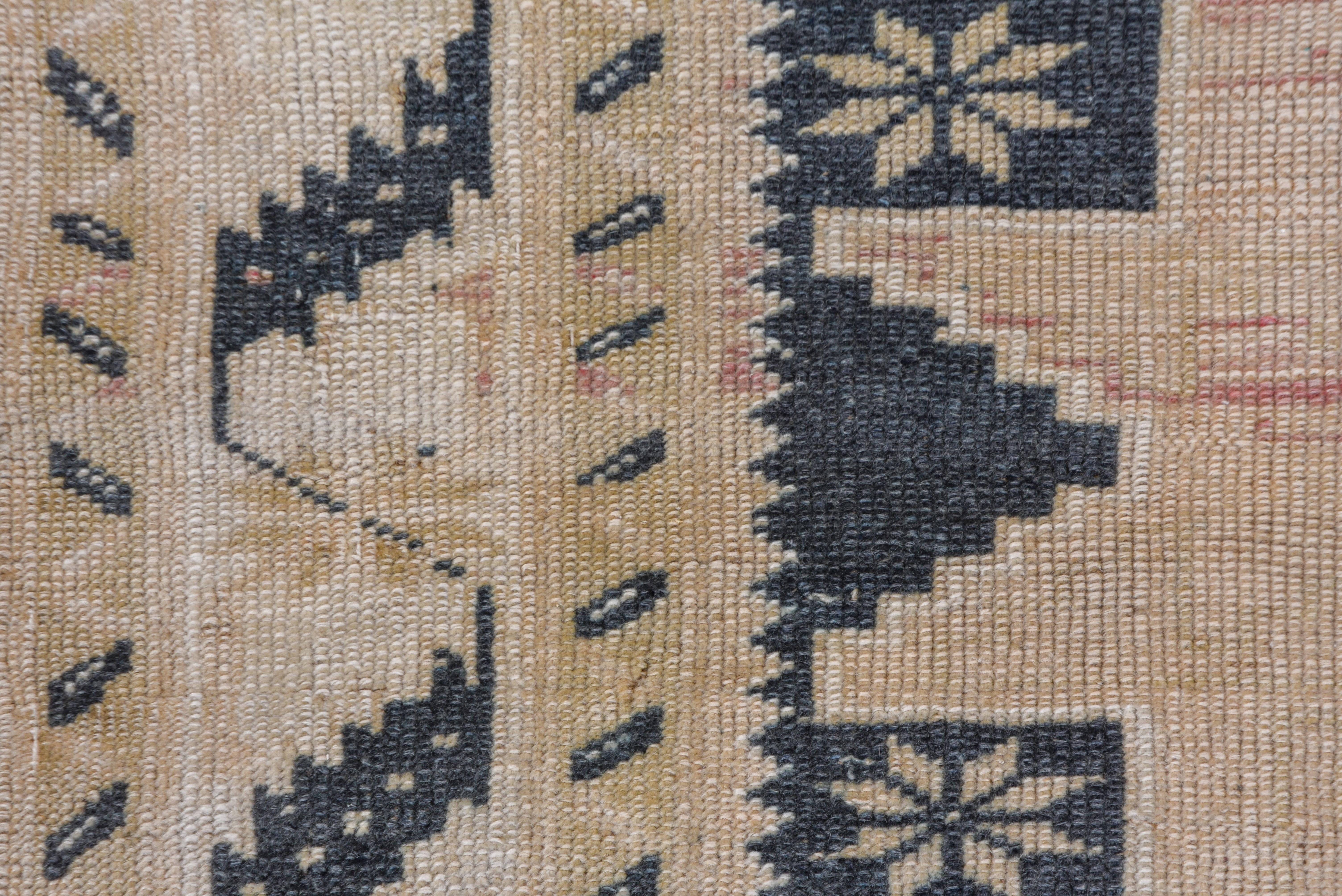 This Oushak rug is wholly in the Caucasian Kuba manner with three nearly conjoint Lesghi 12 point stars on a rosette sprinkled slate ground, within an ecru border featuring a Meander of serrated slant leaves.