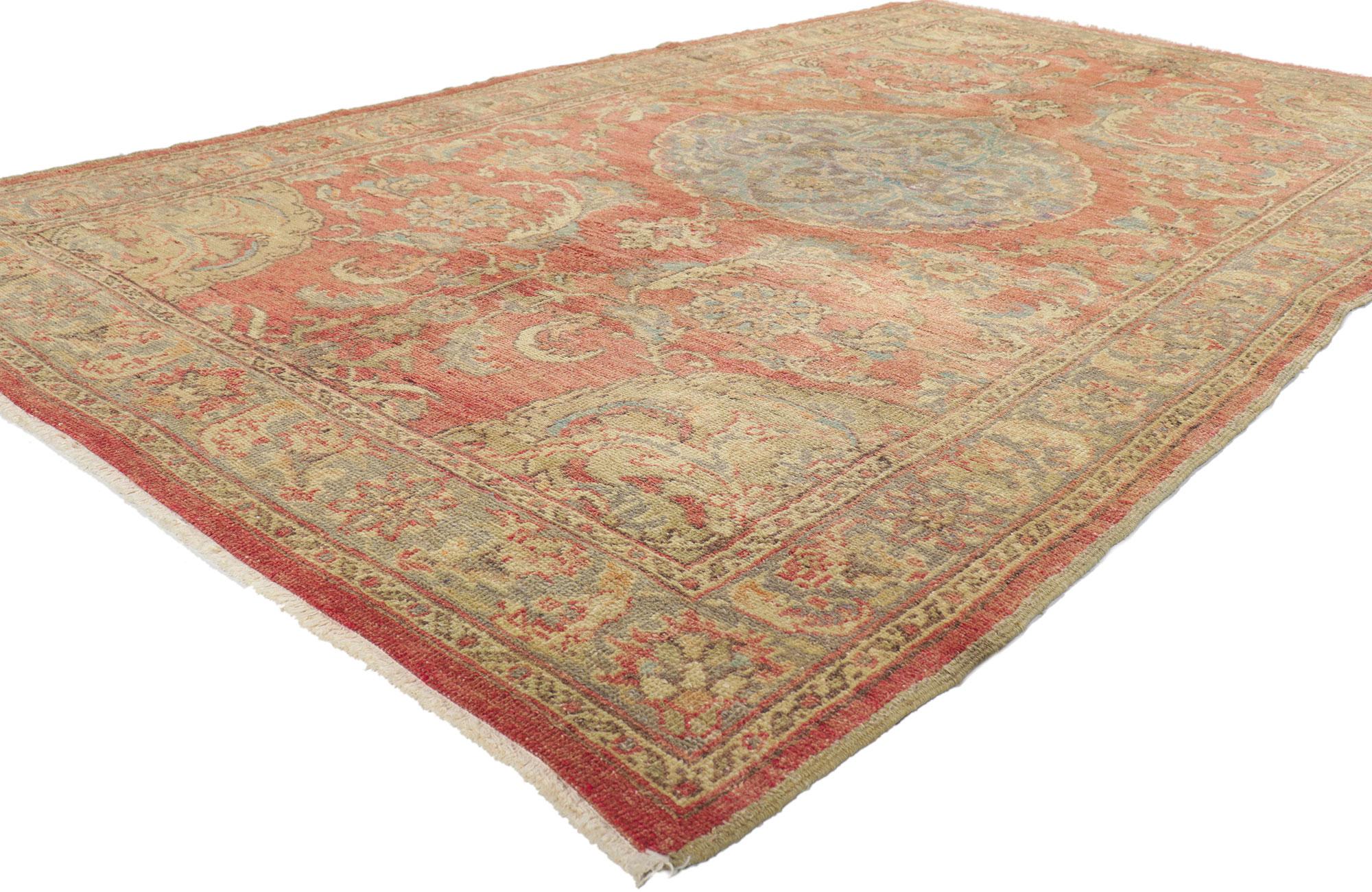 50523 Vintage Turkish Oushak Rug, 05'02 X 08'10.
This hand-knotted wool vintage Turkish Oushak rug features a round scalloped central medallion with palmette pendants floating on an abrashed terra cotta field. Large open blossoms, palmettes, vinery