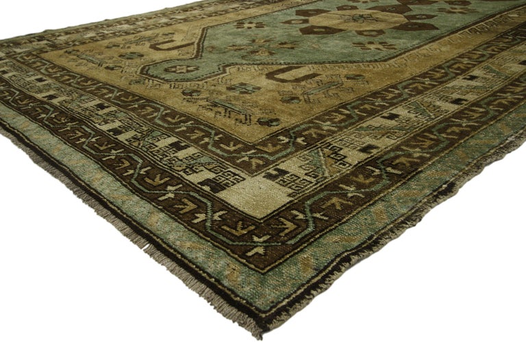 52407 Vintage Turkish Oushak Gallery Rug, Anatolian Turkish Prayer Rug 06'03 x 11'04. This hand knotted wool vintage Turkish Oushak runner features a long oversize hooked hexagonal medallion with octagonal pendants spread across an abrashed camel