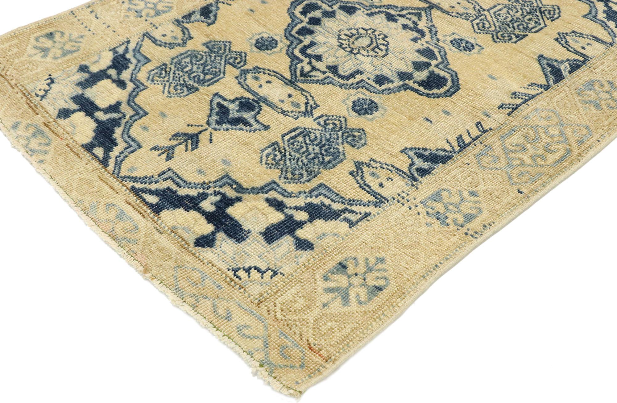 53041 vintage Turkish Oushak rug Warm Mediterranean Coastal style. Effortless beauty and simplicity meet warm beiges and deep blues with a subtle Mediterranean style in this hand knotted wool vintage Turkish Oushak rug. The ecru-tan antique washed
