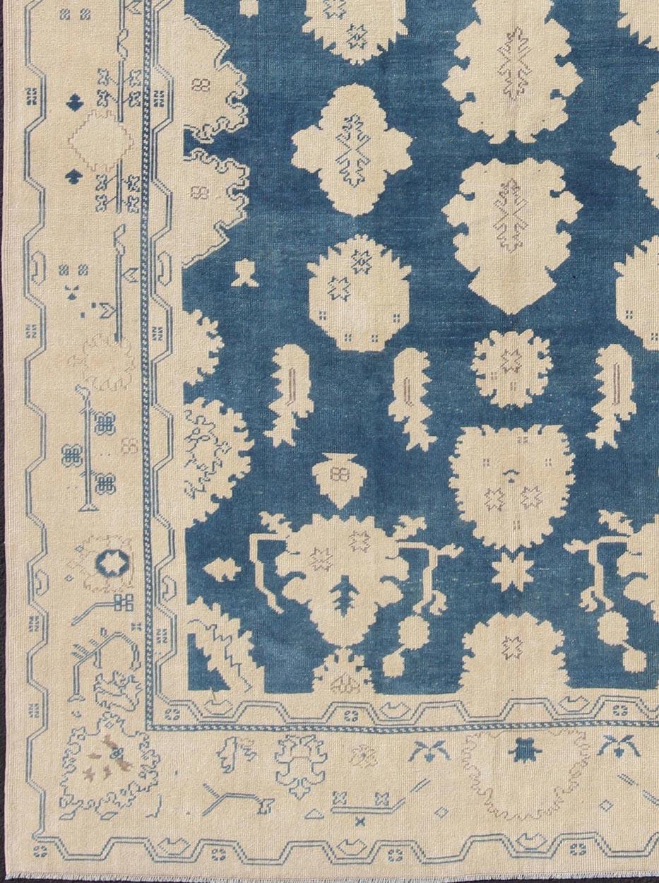 Nude and Royal blue Oushak rug vintage from Turkey with all-over design of etched motifs, rug en-165934, country of origin / type: Turkey / Oushak, circa 1940.

This striking vintage Turkish Oushak rug bears a royal blue-colored body that is