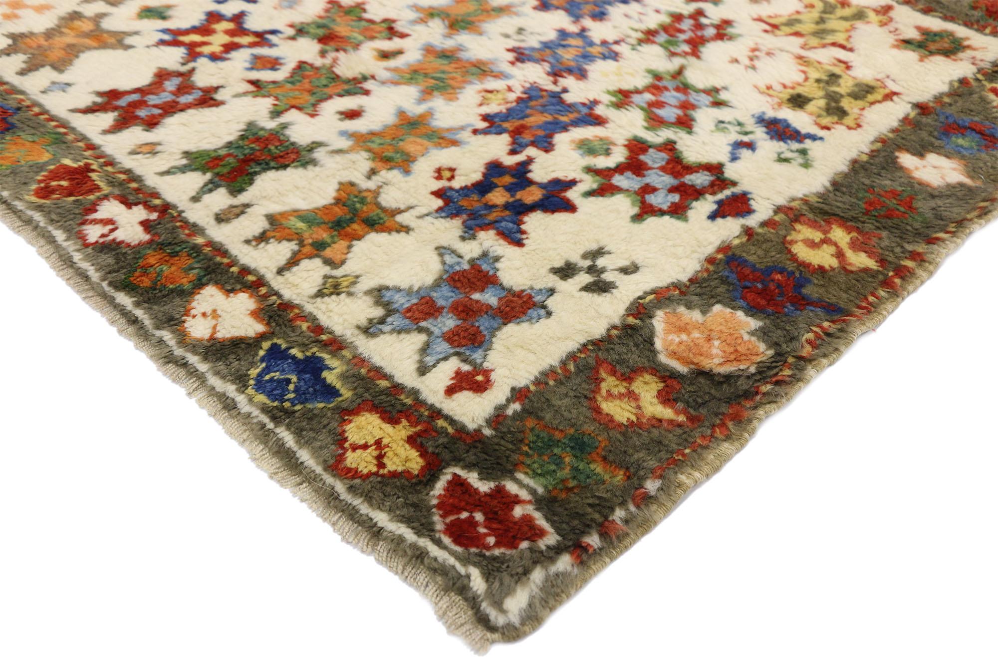 52447, vintage Turkish Oushak rug with Boho Tribal style. This hand knotted wool vintage Turkish Oushak rug with Boho Tribal style features a poly-chromatic field of eight-pointed stars representing happiness in a myriad of colors arranged in