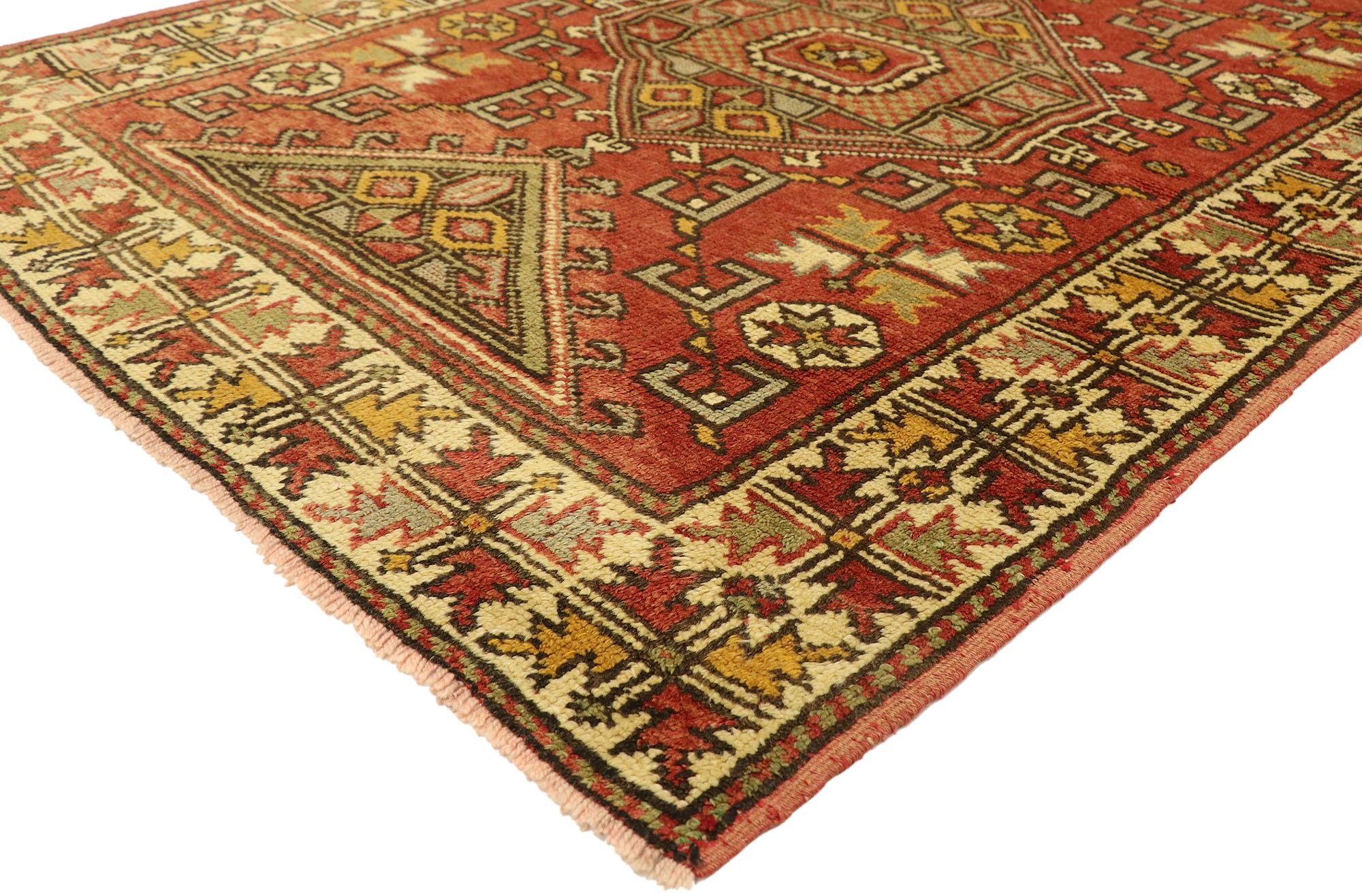 51080, Vintage Turkish Oushak Rug with Bungalow Style. With its rustic Bungalow style and warm earth-tone colors, this hand knotted wool vintage Turkish Oushak gallery rug astounds with its beauty. The abrashed brick red field features one large