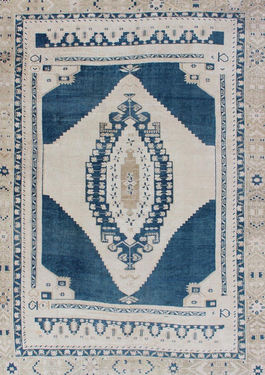 Hand-Knotted Vintage Turkish Oushak Rug with Central Medallion in Blue and Cream For Sale
