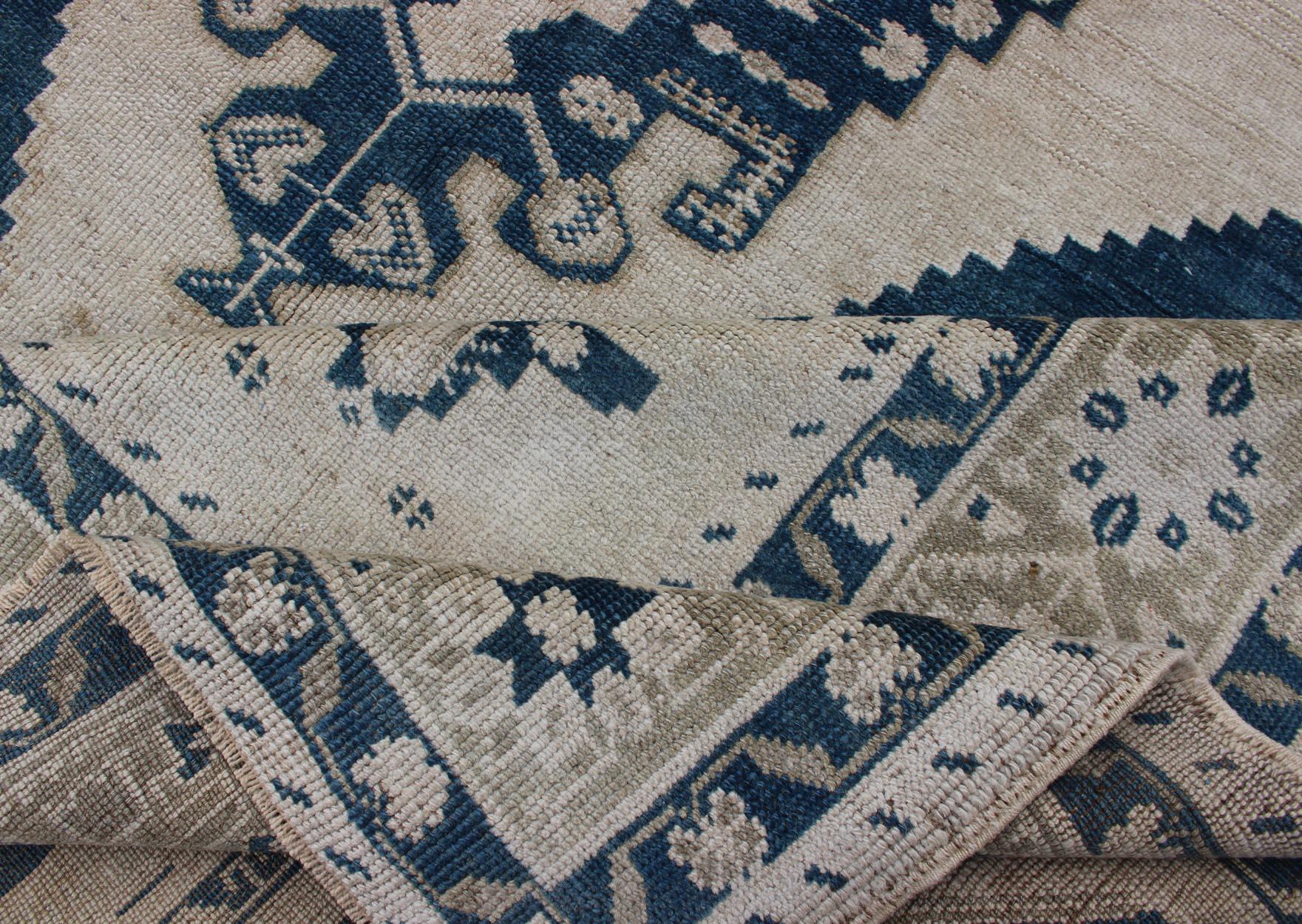 Mid-20th Century Vintage Turkish Oushak Rug with Central Medallion in Blue and Cream For Sale