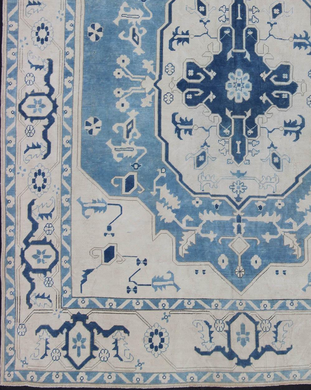 This unique vintage Oushak from Turkey displays cream/ivory background with variety of blue colors on a medallion design. rug en-165880, country of origin / type: Turkey / Oushak, circa 1940

This vintage Oushak carpet features a navy blue in the