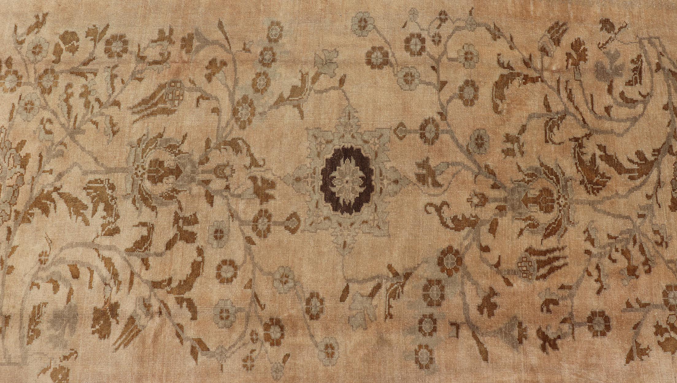 Measures: 6'9 x 9'11

The Oushak wool rug features two oversized medallions with detailed vines and flowers. A framework of floral motifs and stylized branches form the border and beautifully complements the aesthetic of this carpet. This rug has
