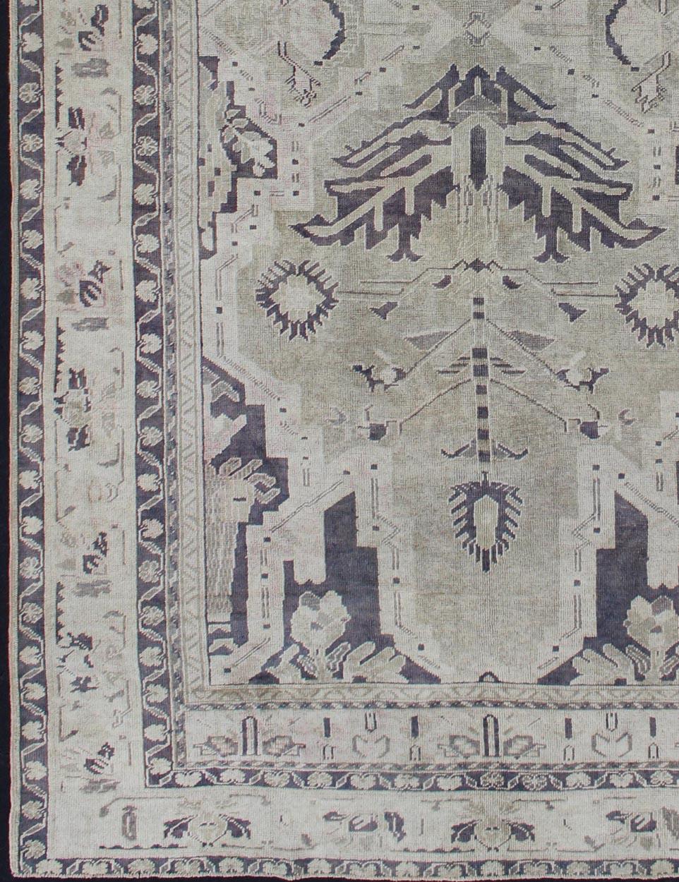 Dual medallion design Turkish vintage rug in neutral tones, dark blue and taupe rug en-165961, country of origin / type: turkey / Oushak, circa 1950

This vintage Turkish Oushak carpet (circa mid-20th century) features a dual medallion design, as