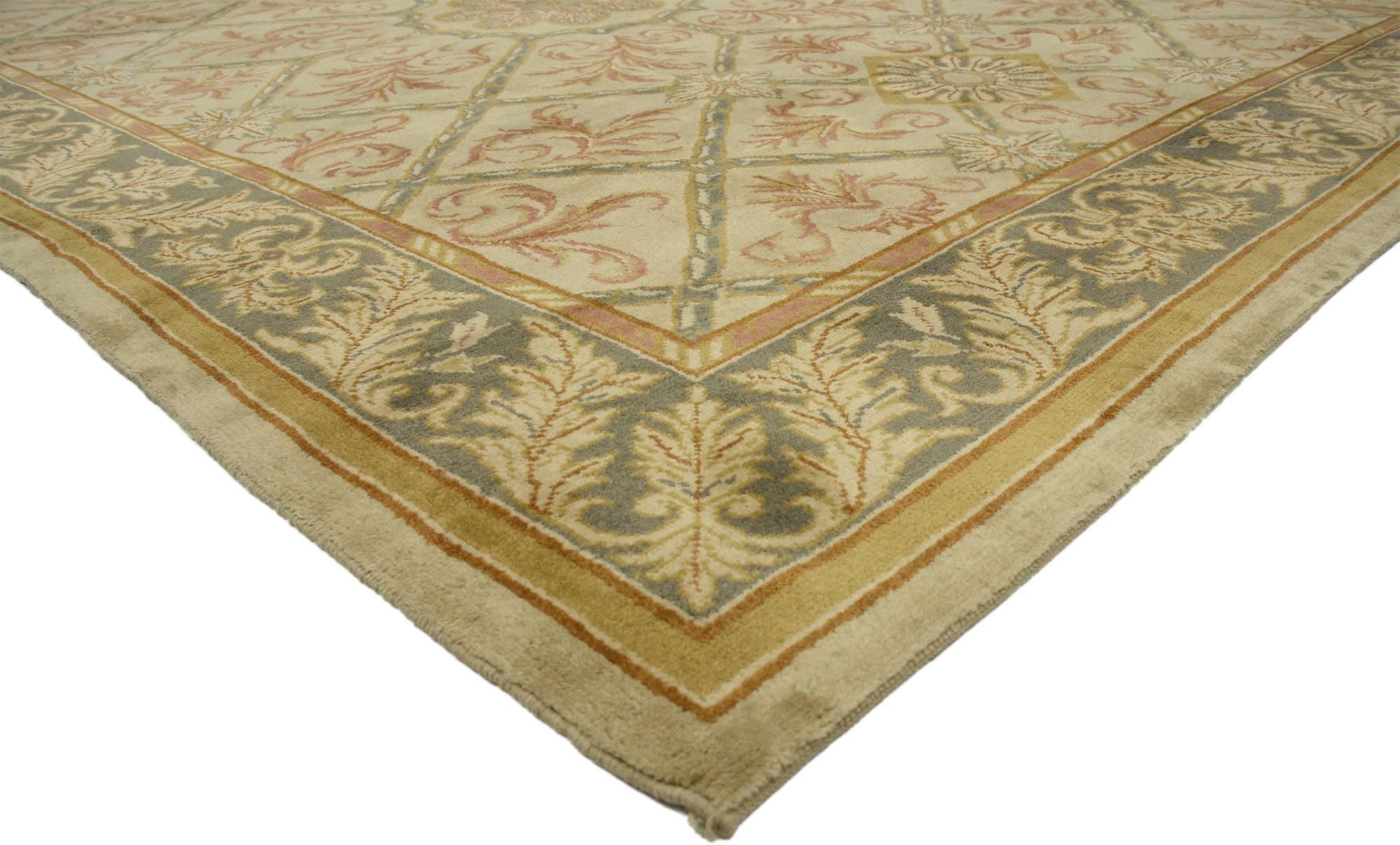 77116, vintage Turkish Oushak rug with Elizabethan style and French Influence. This hand knotted wool vintage Turkish Oushak rug features a central roundel surrounded by an all-over garden lattice design composed of a symmetrical diamond scroll