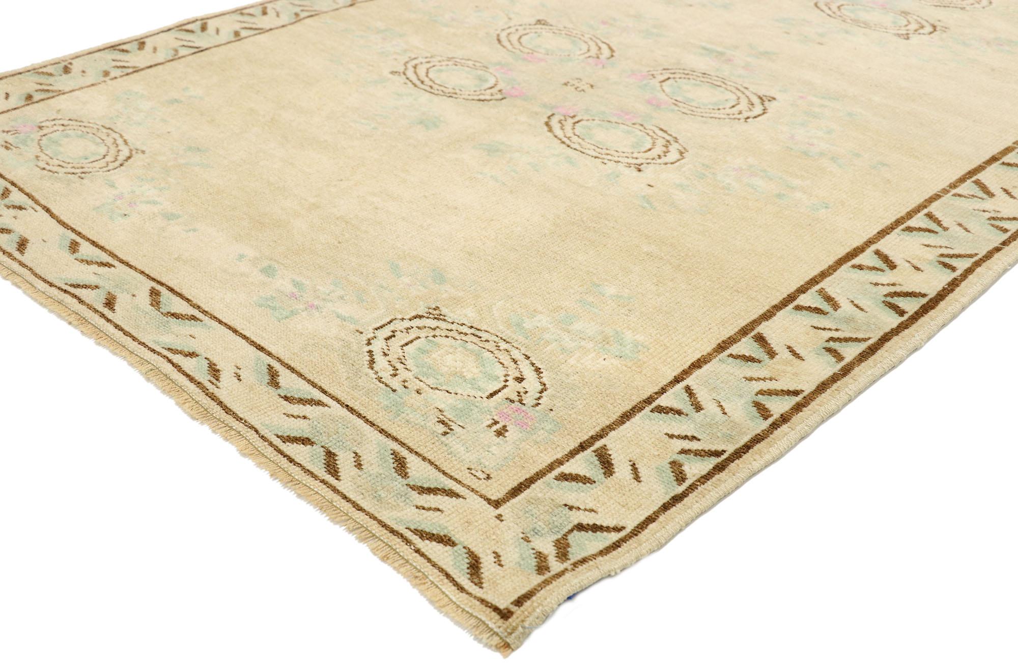 52984 Vintage Turkish Oushak Rug with English Country Cottage Style. Soft, bespoke vibes meet English Country Cottage style in this hand knotted wool vintage Turkish Oushak rug. The champagne antique washed field beautifully displays two leafy