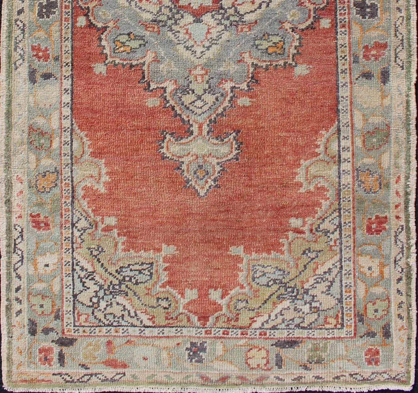 Hand-Knotted Vintage Turkish Oushak Rug with Layered Medallion on Soft Coral Color Background For Sale